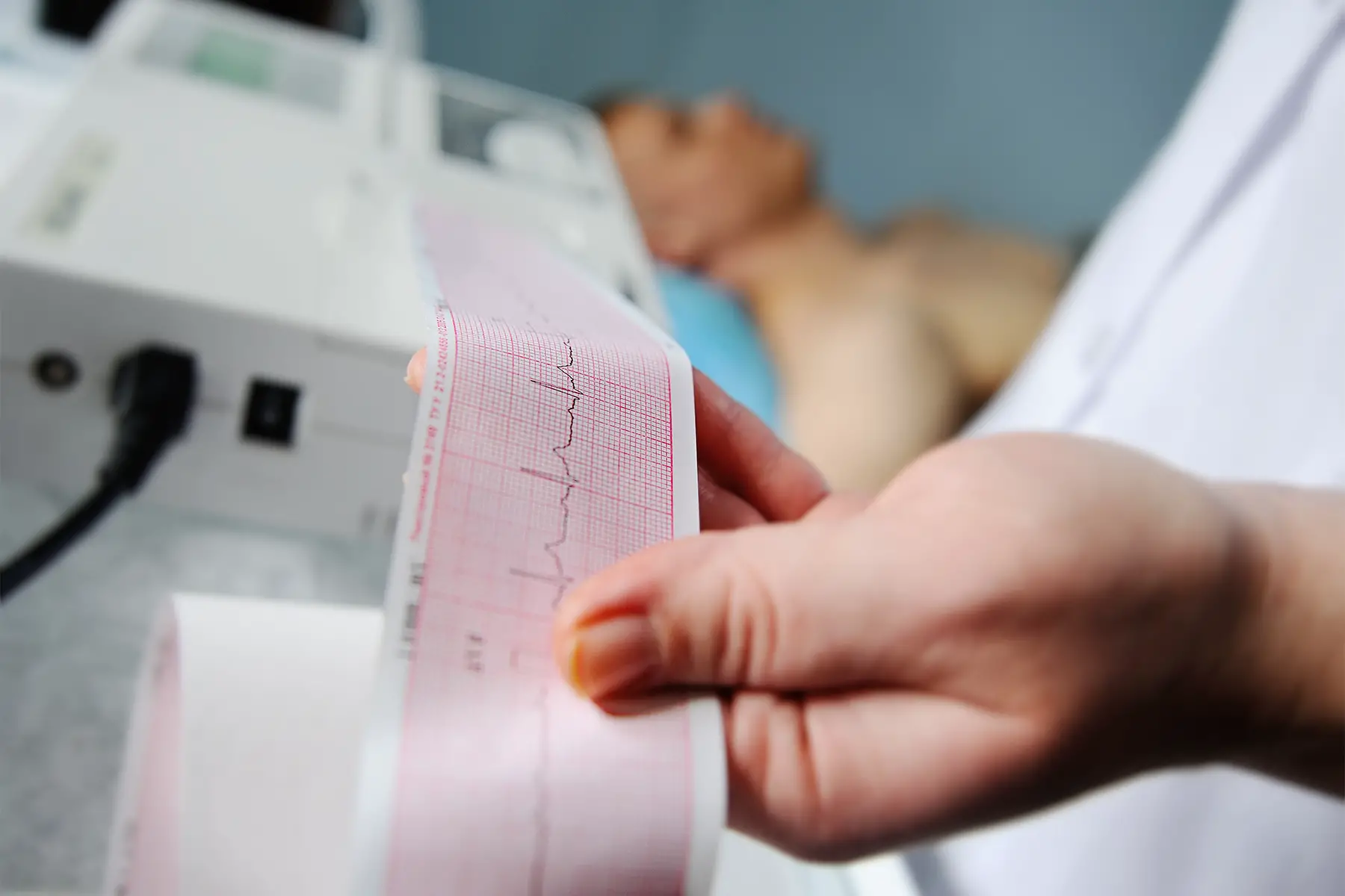 a cardiologist printing a cardiogram for a male patient