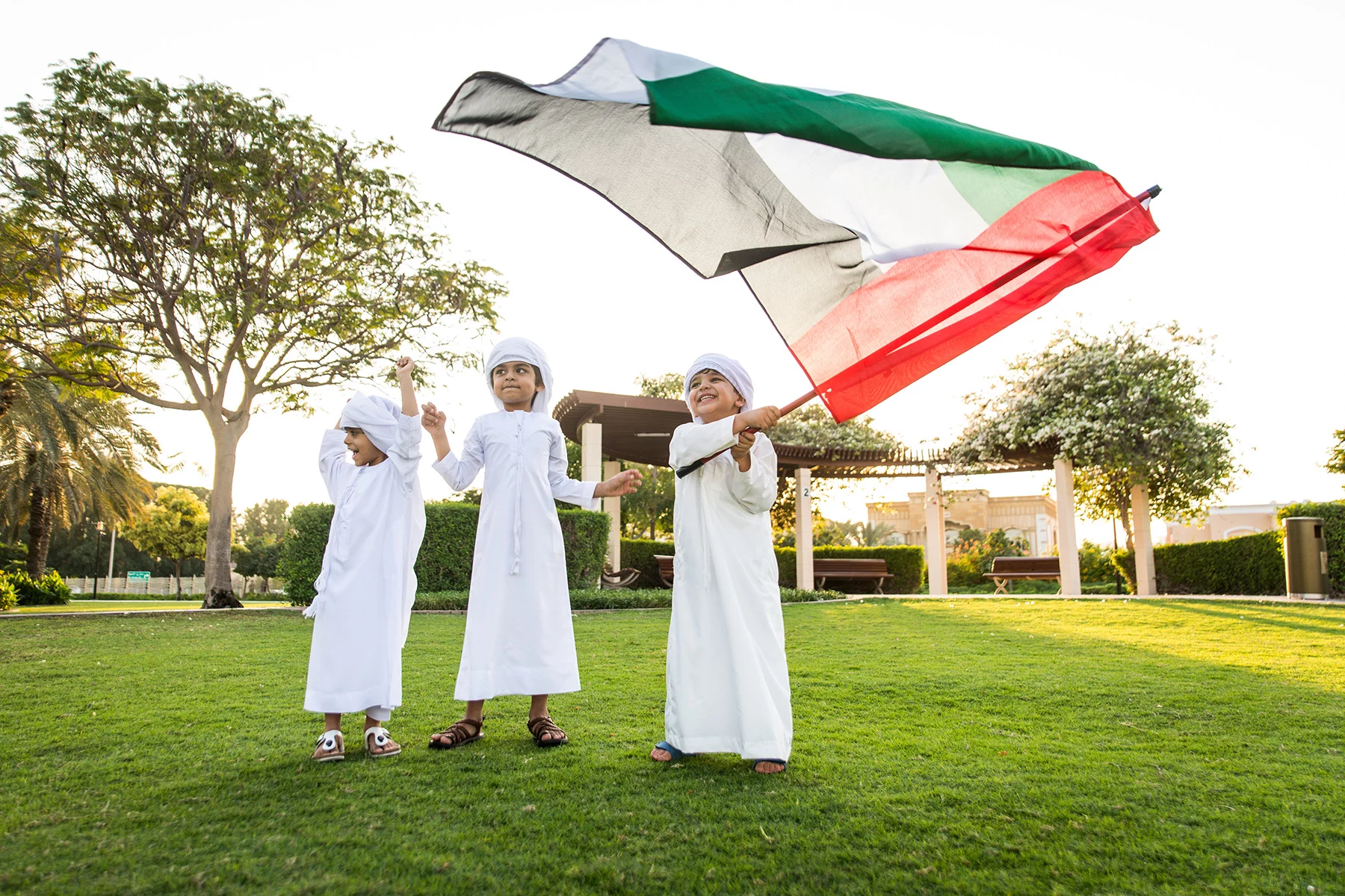 Children waving an Emirati flag