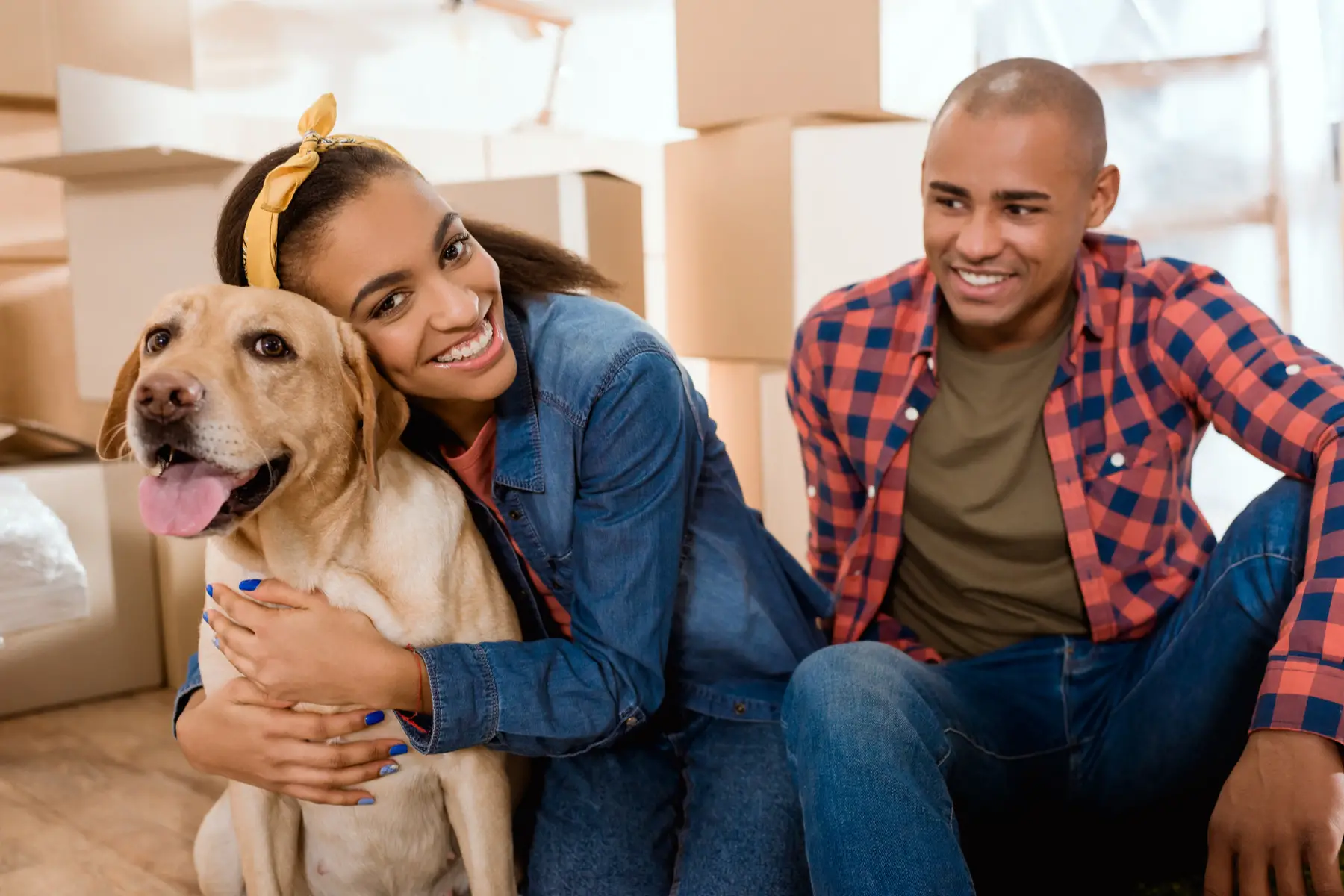 young couple moving house with their  dog