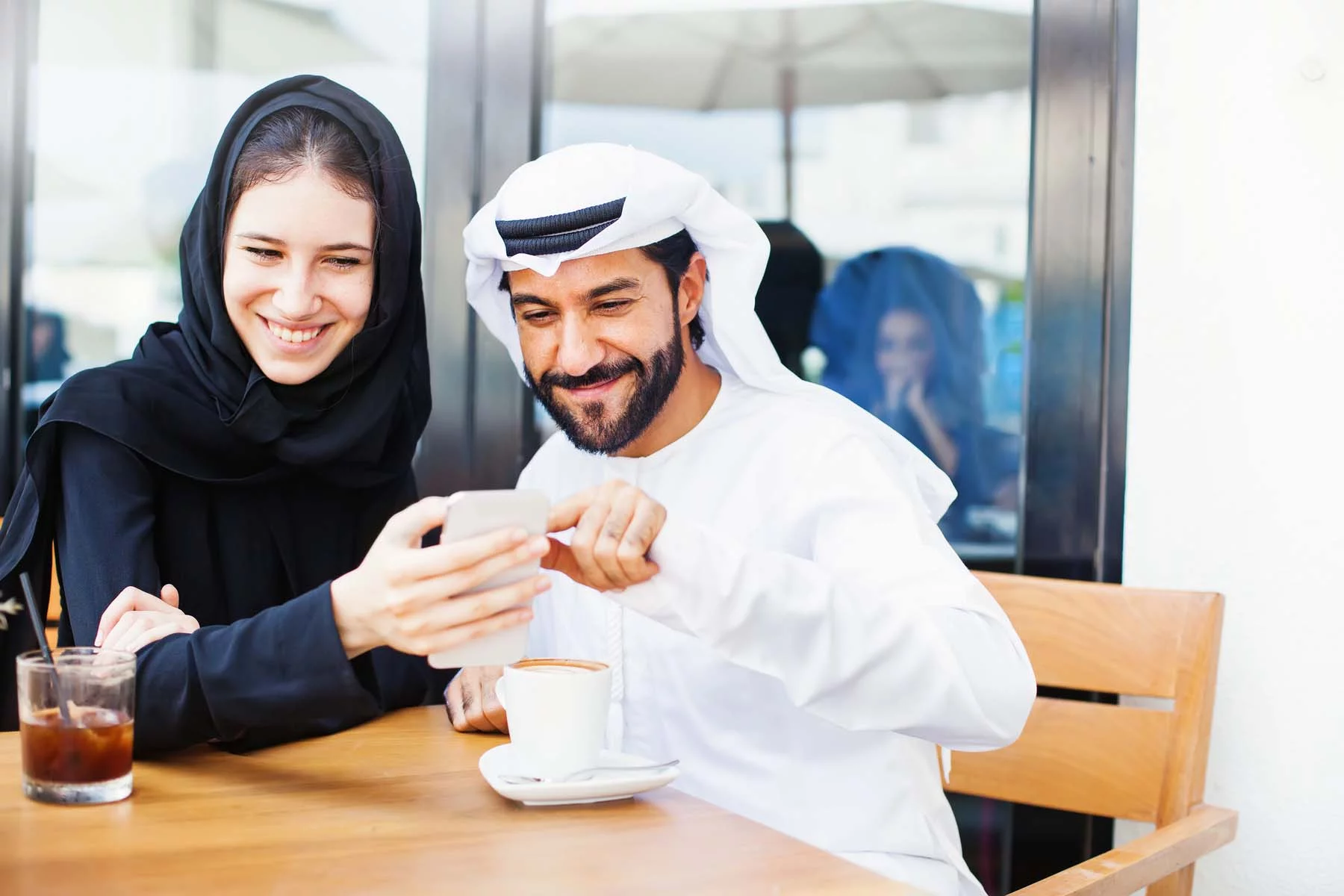 couple looking at phone in traditional clothing