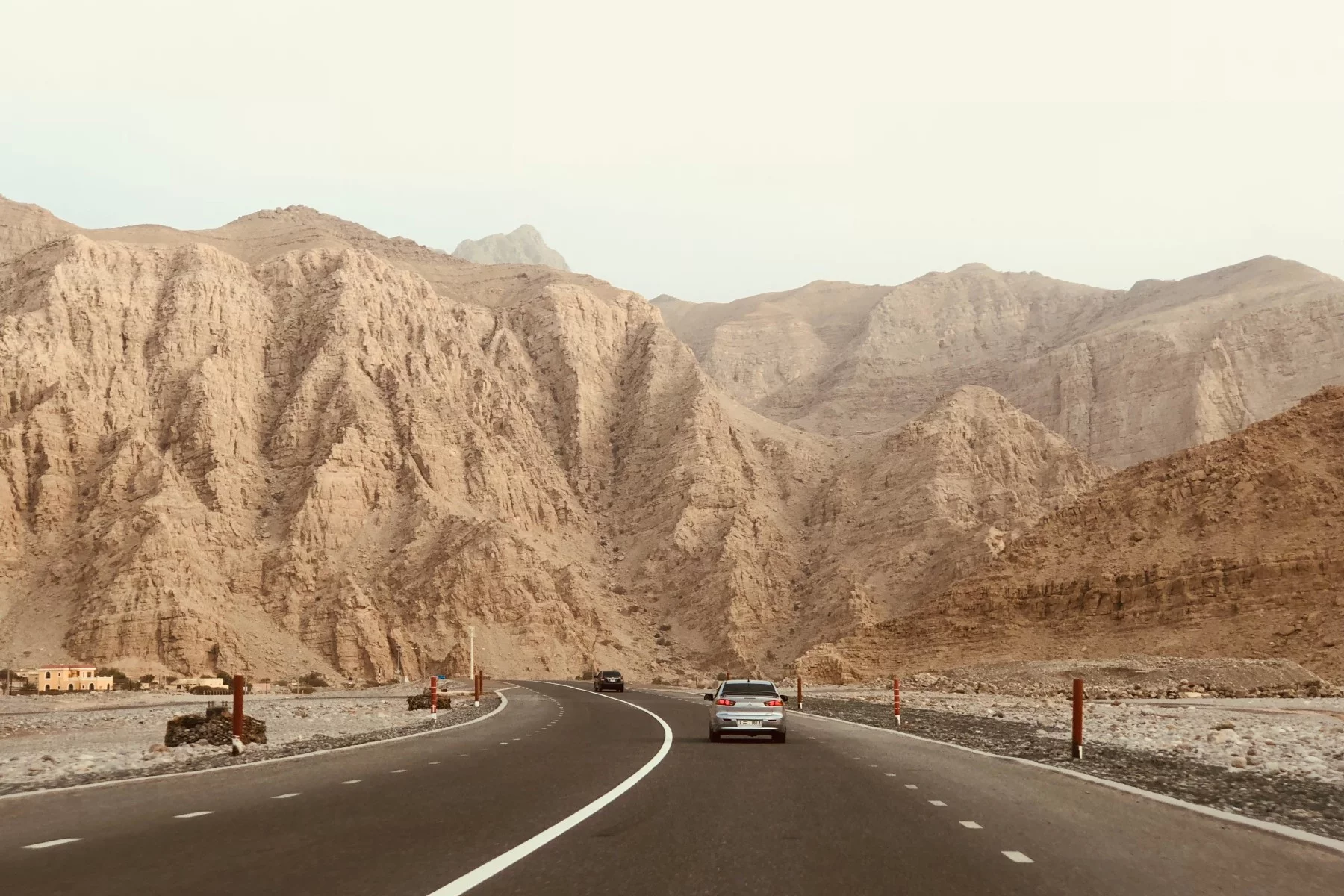 Driving on the road near the Jabal Bil Ays mountain range, UAE.