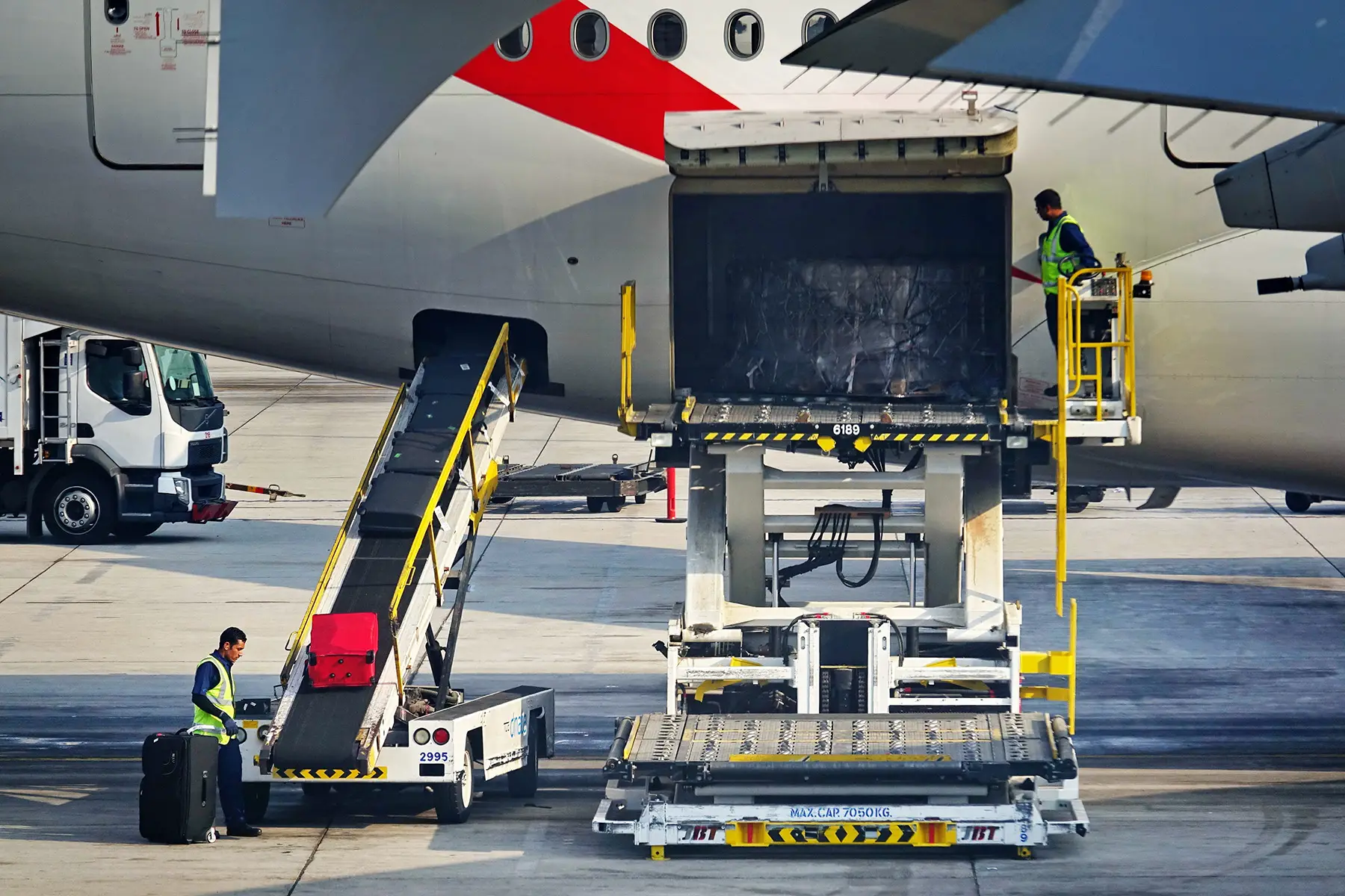 Staff loading luggage at Dubai International Airport