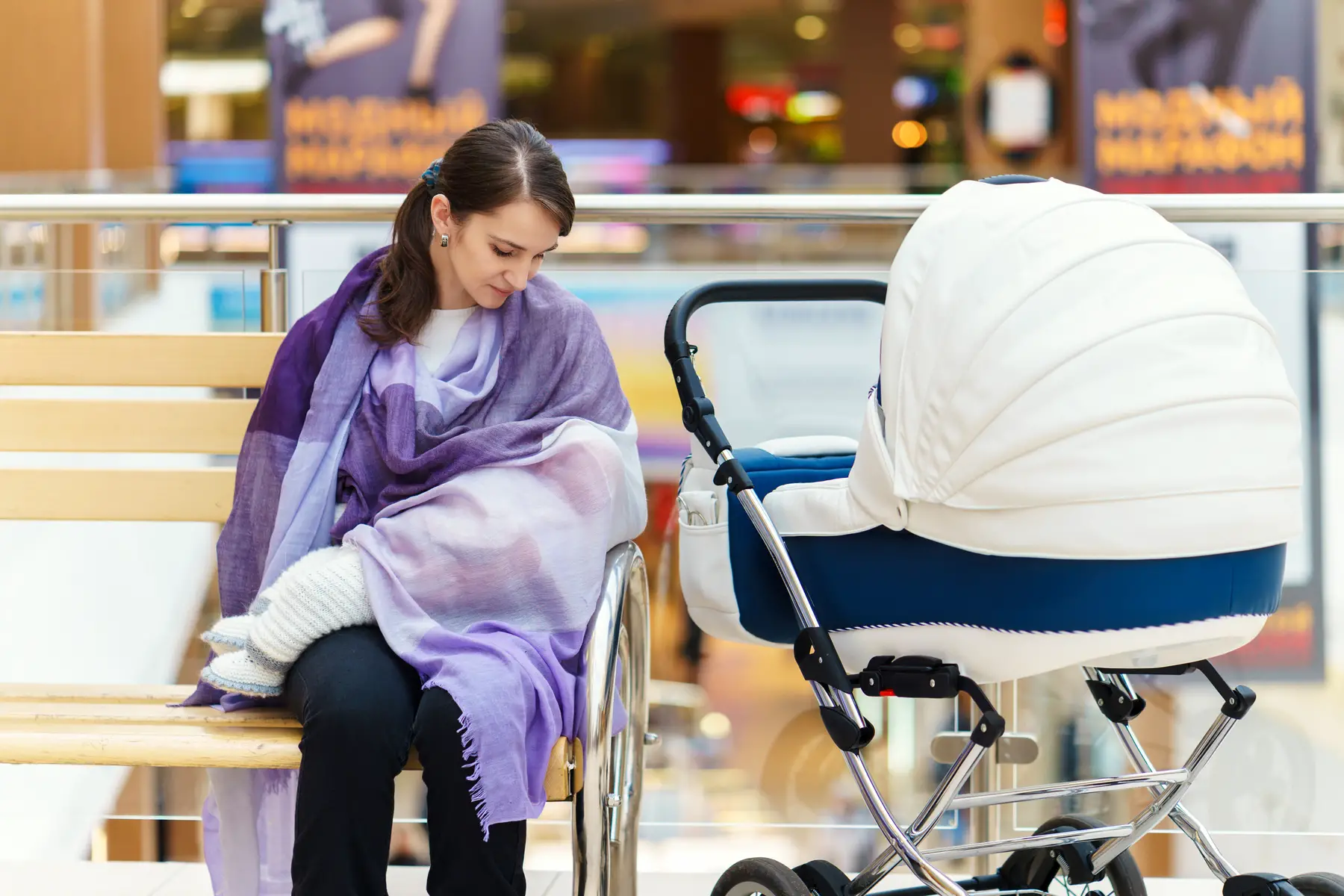 Mother breastfeeding in a mall