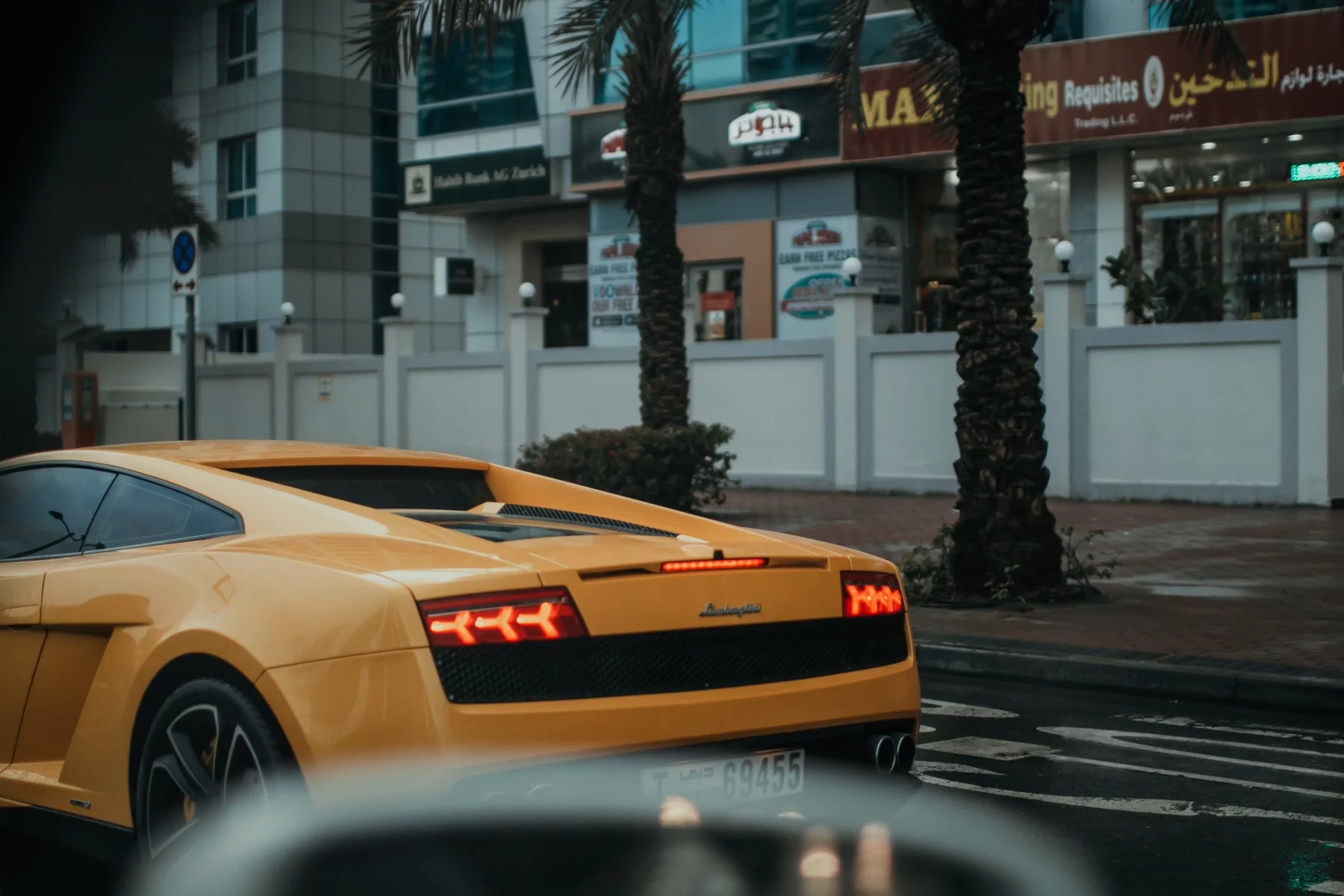 Expensive-looking Lamborghini sports car driving in the streets of the UAE.