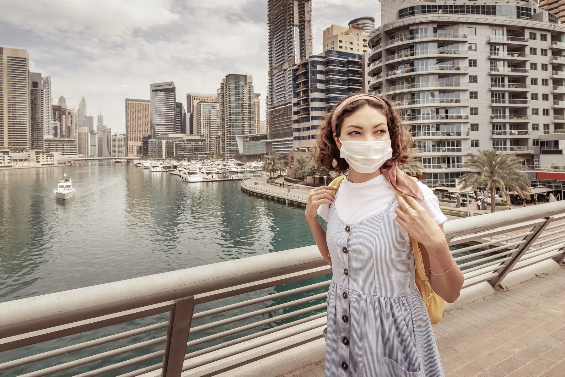 a woman wearing a face mask due to Covid-19 in Dubai