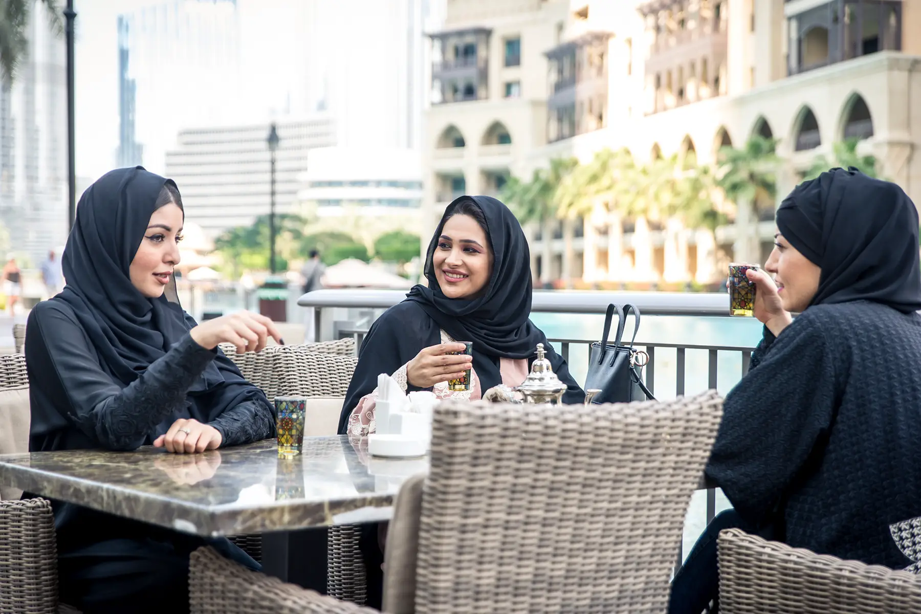 Three women in Dubai at a table drinking tea