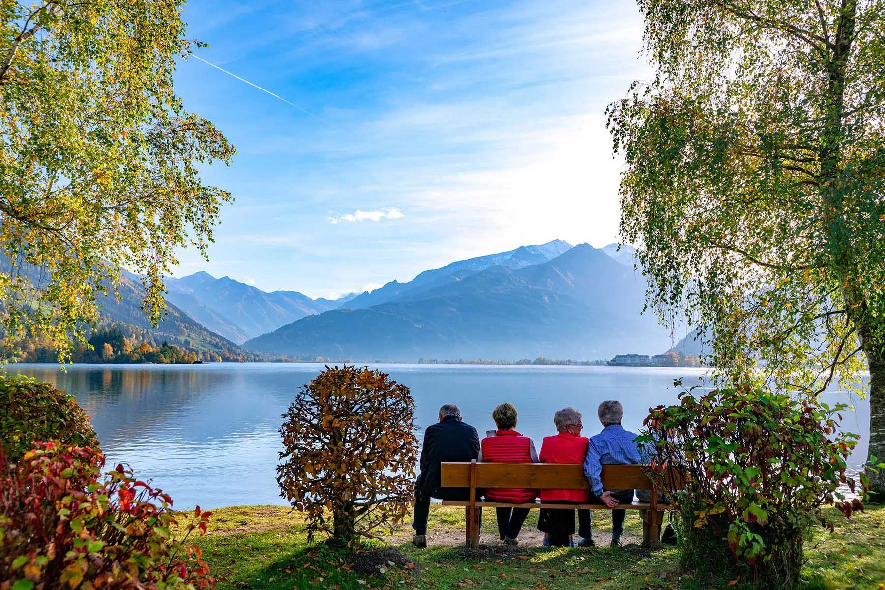 Five retirees sharing a bench overlooking a lake in Salzkammergut, Austria