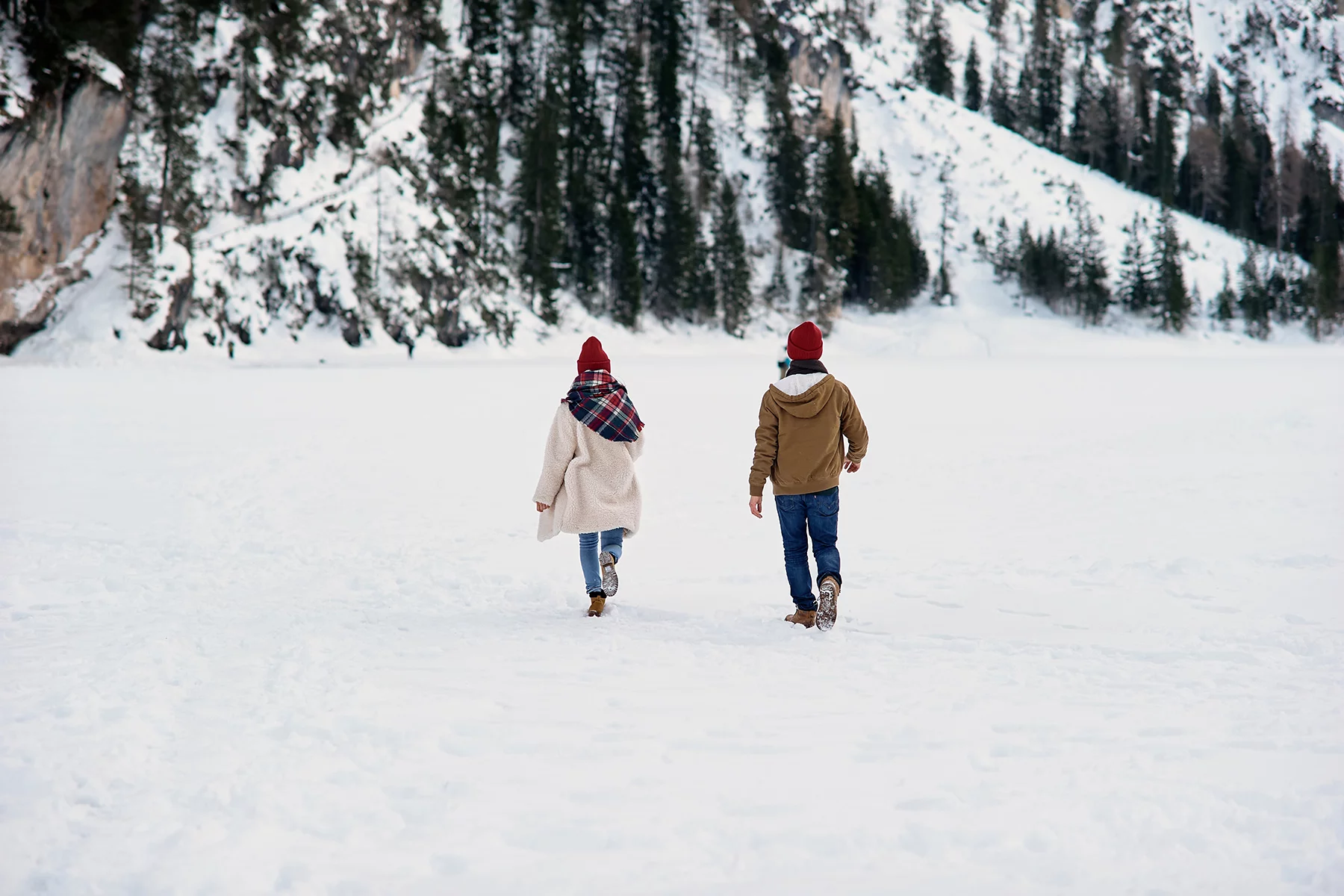 Couple walking through the snow on a date
