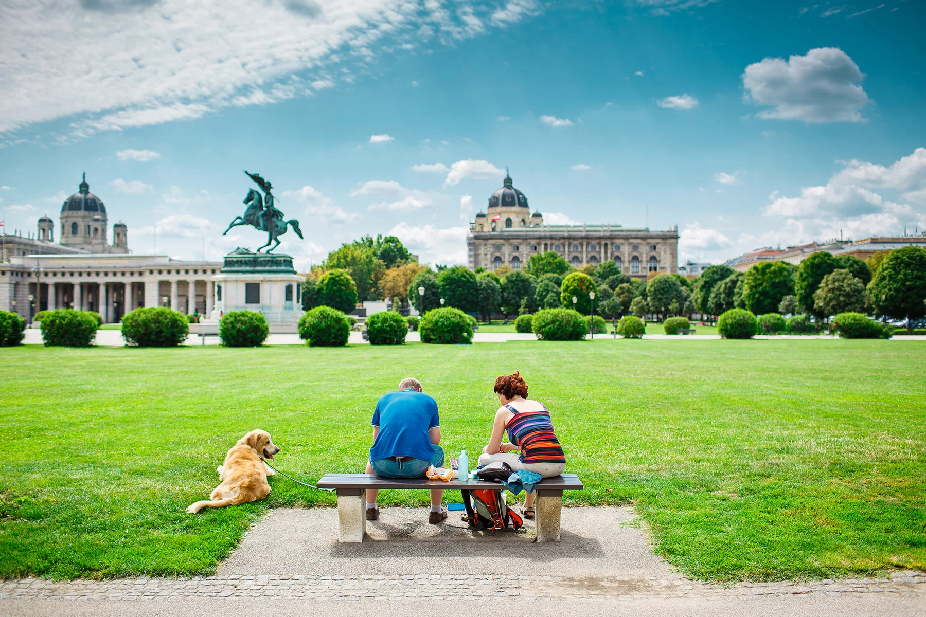 A dog with his owners in a Vienna park