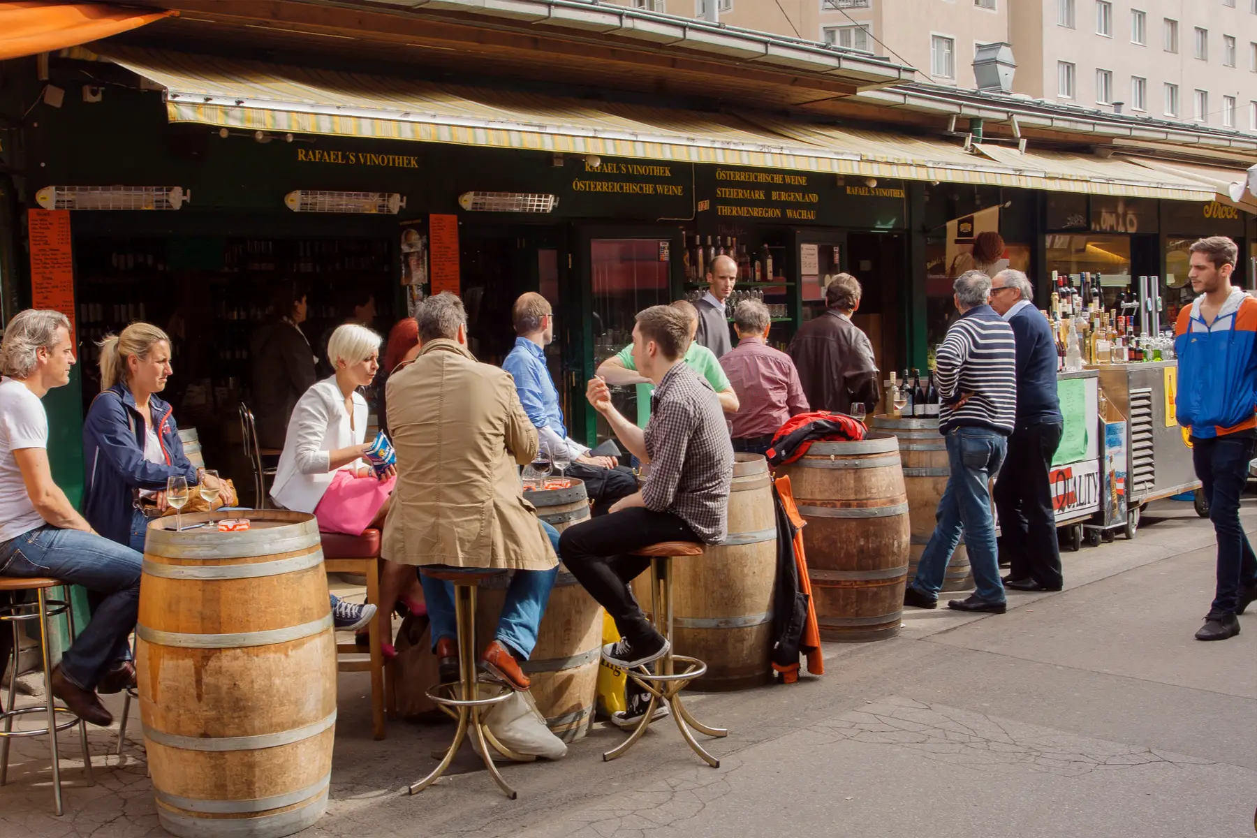 Patrons drinking wine at a Schanigarten in Vienna