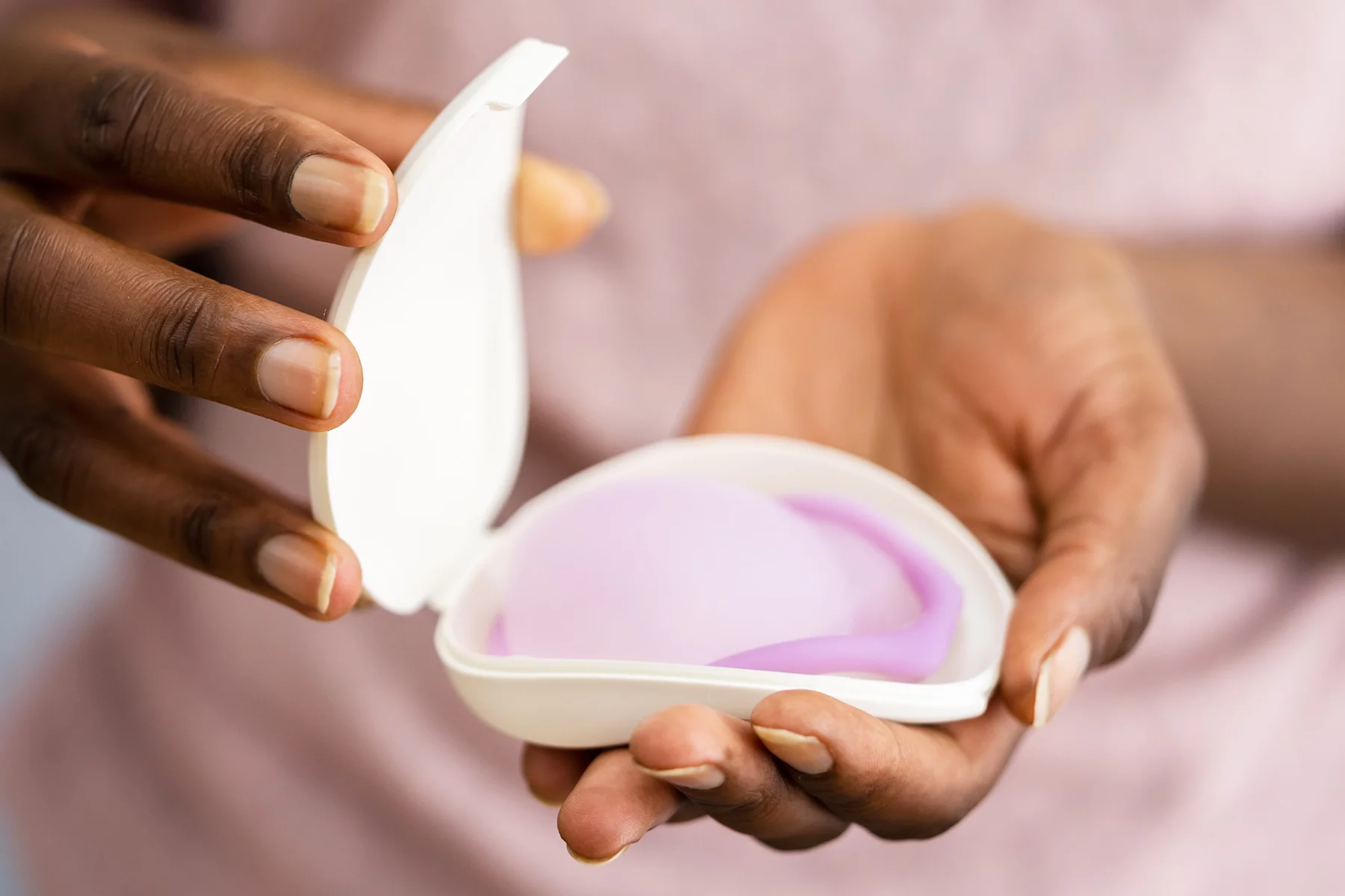 woman holding a diaphragm contraceptive
