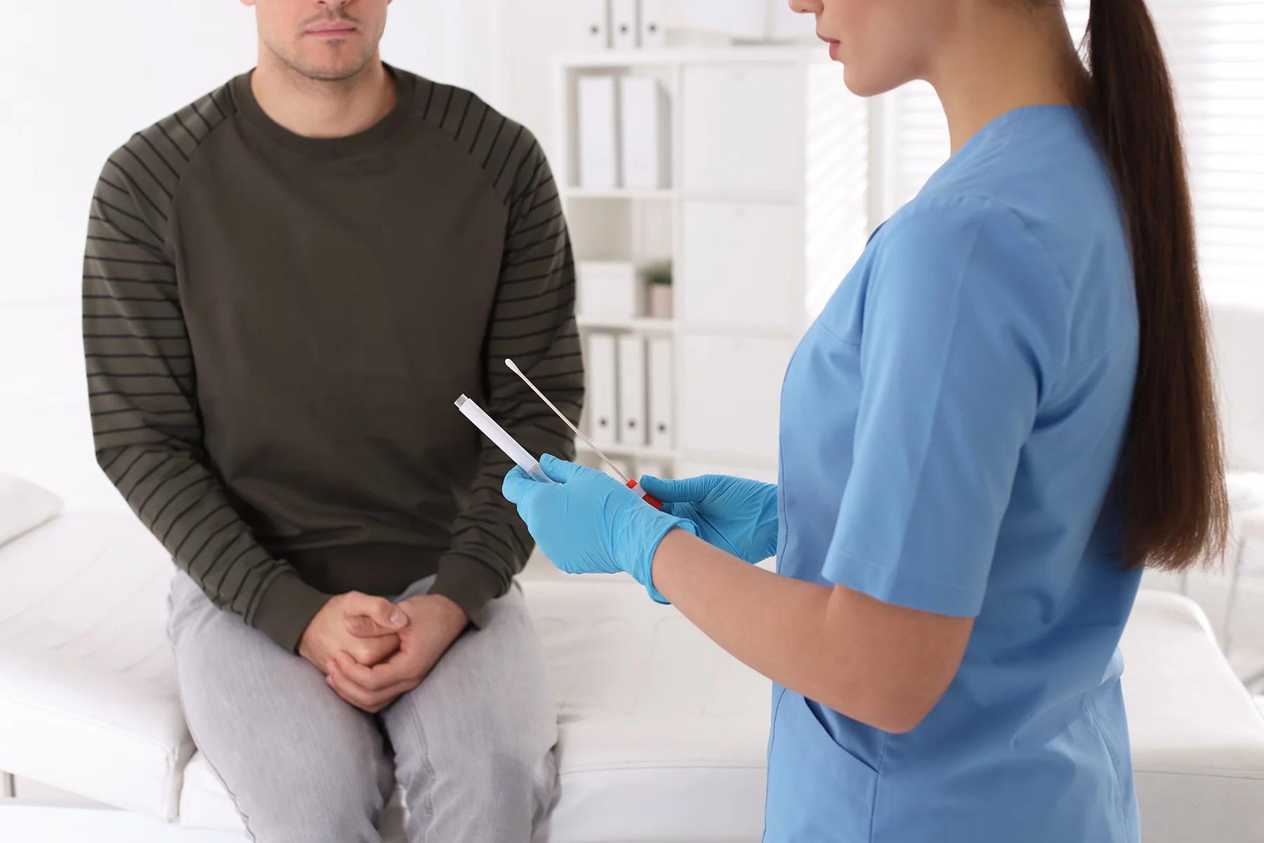 a doctor taking a sample for an STD test at a health clinic