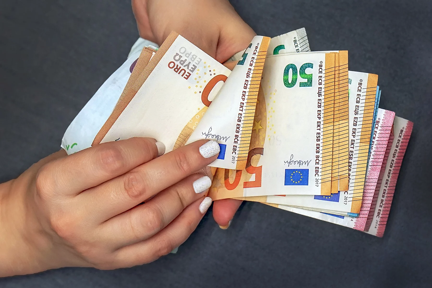 Woman counting euro notes