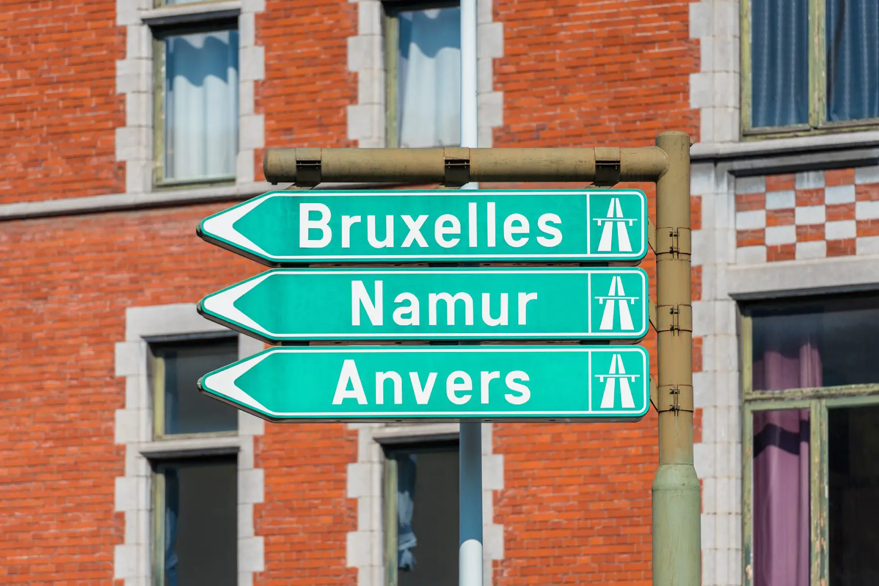 green colored directional signs to Brussels, Namur, and Antwerp in Liège, Belgium