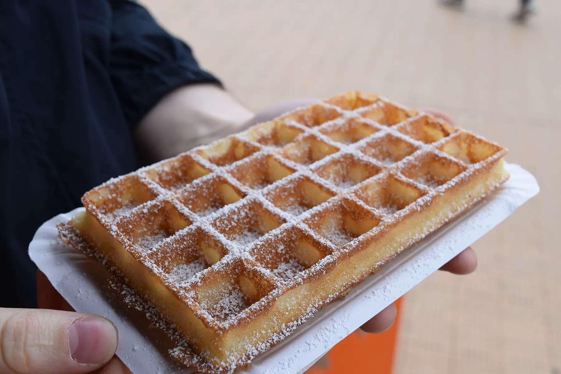 Belgian waffle covered in powdered sugar