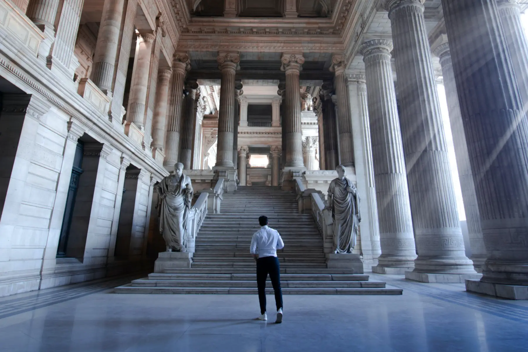 Would-be-citizen walking towards the steps inside the Palace of Justice, Brussels, Belgium.