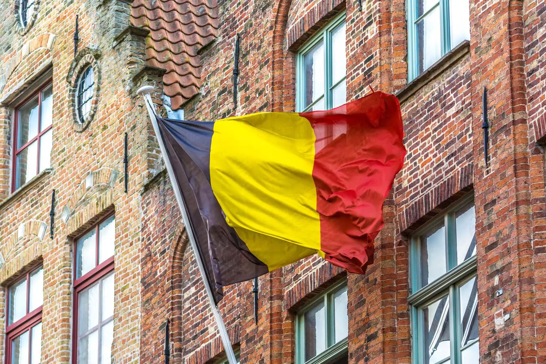 belgian flag flying off a building