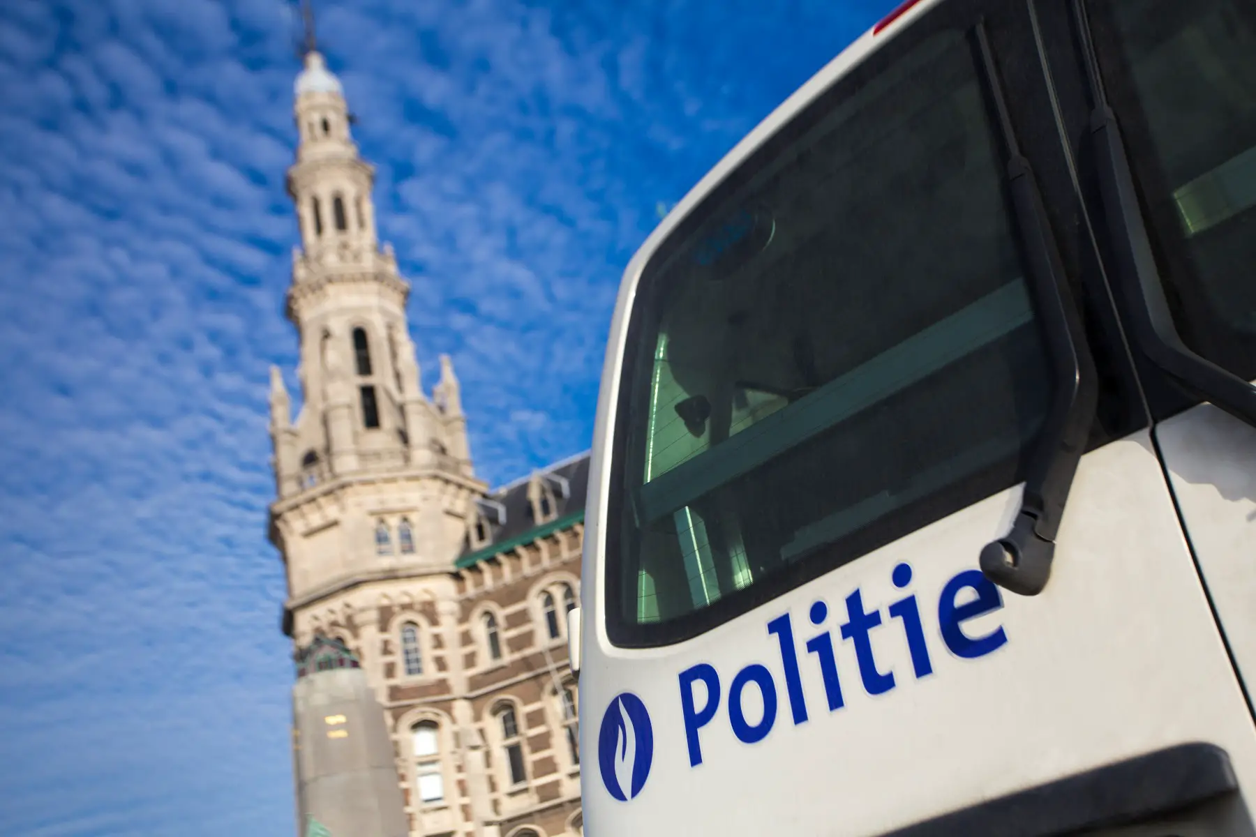 Police car with the Ghent Belfry in the background