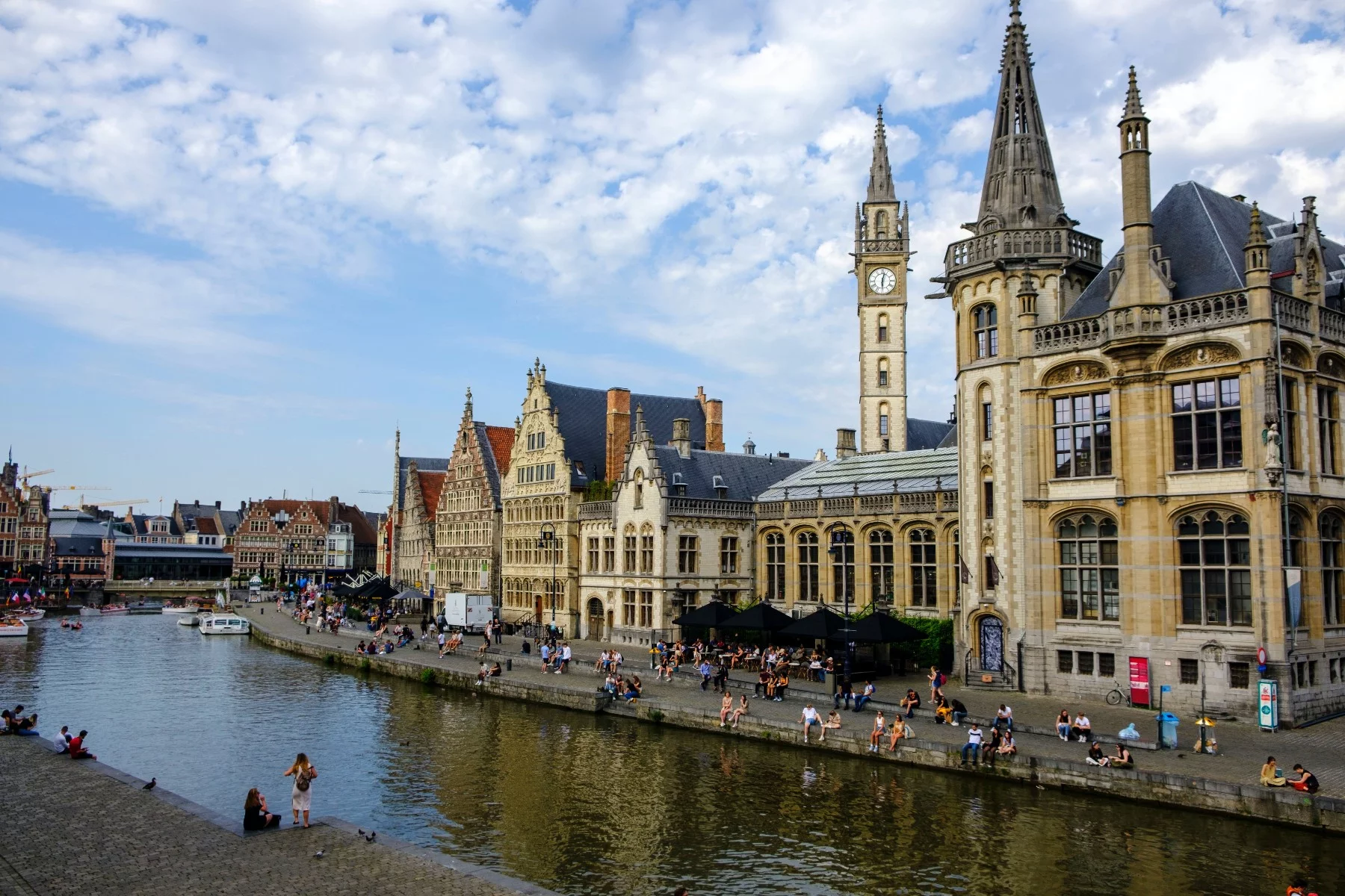 Residents sitting along the canal in Ghent, Belgium.
