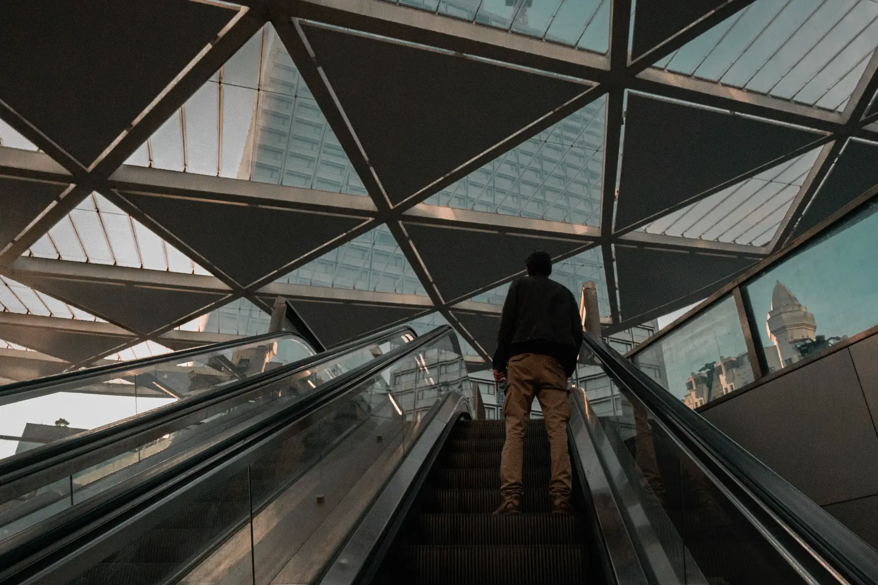 Man going up the escalator