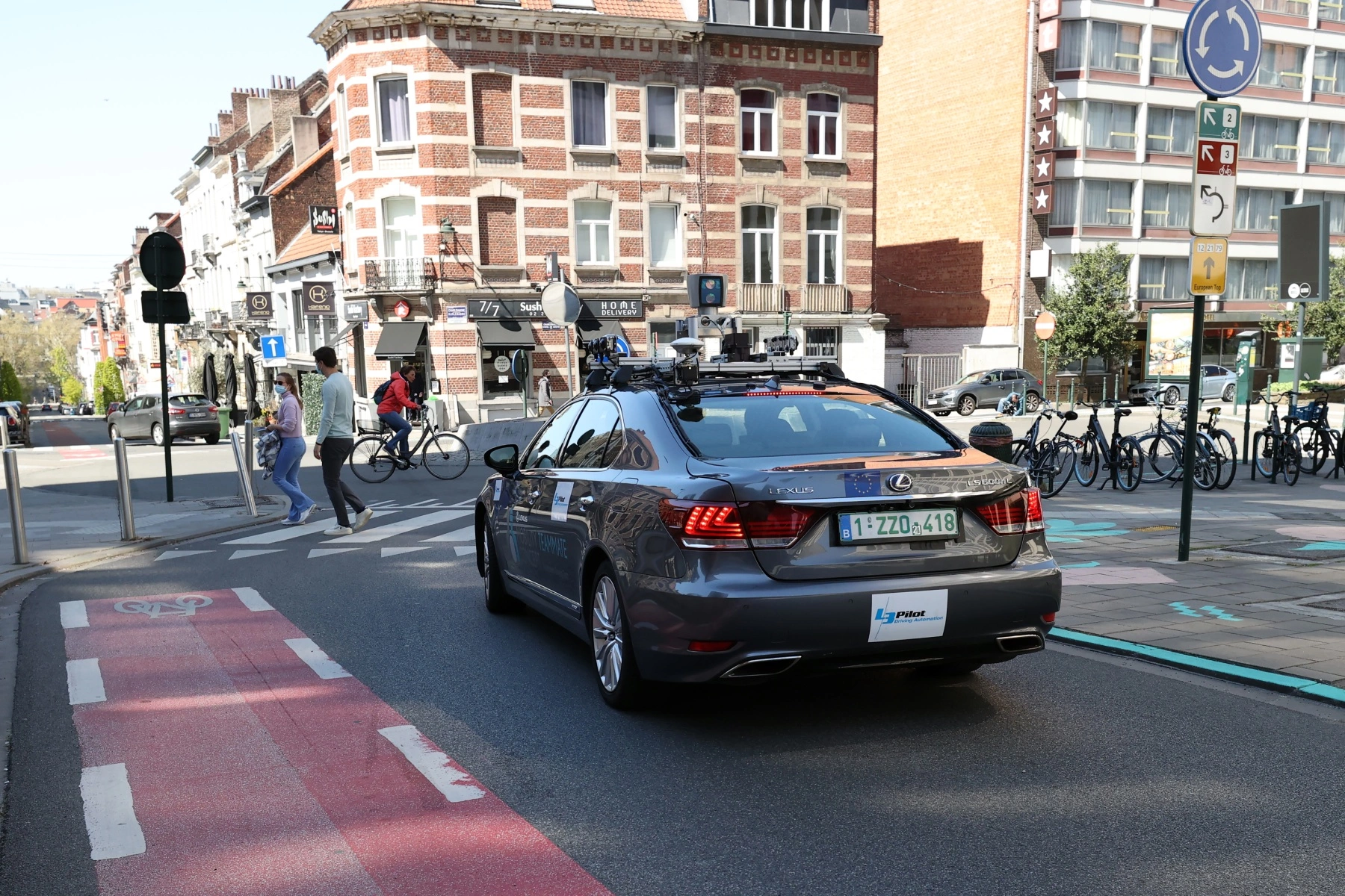 rear shot of a Lexus driving through the streets of Brussels 