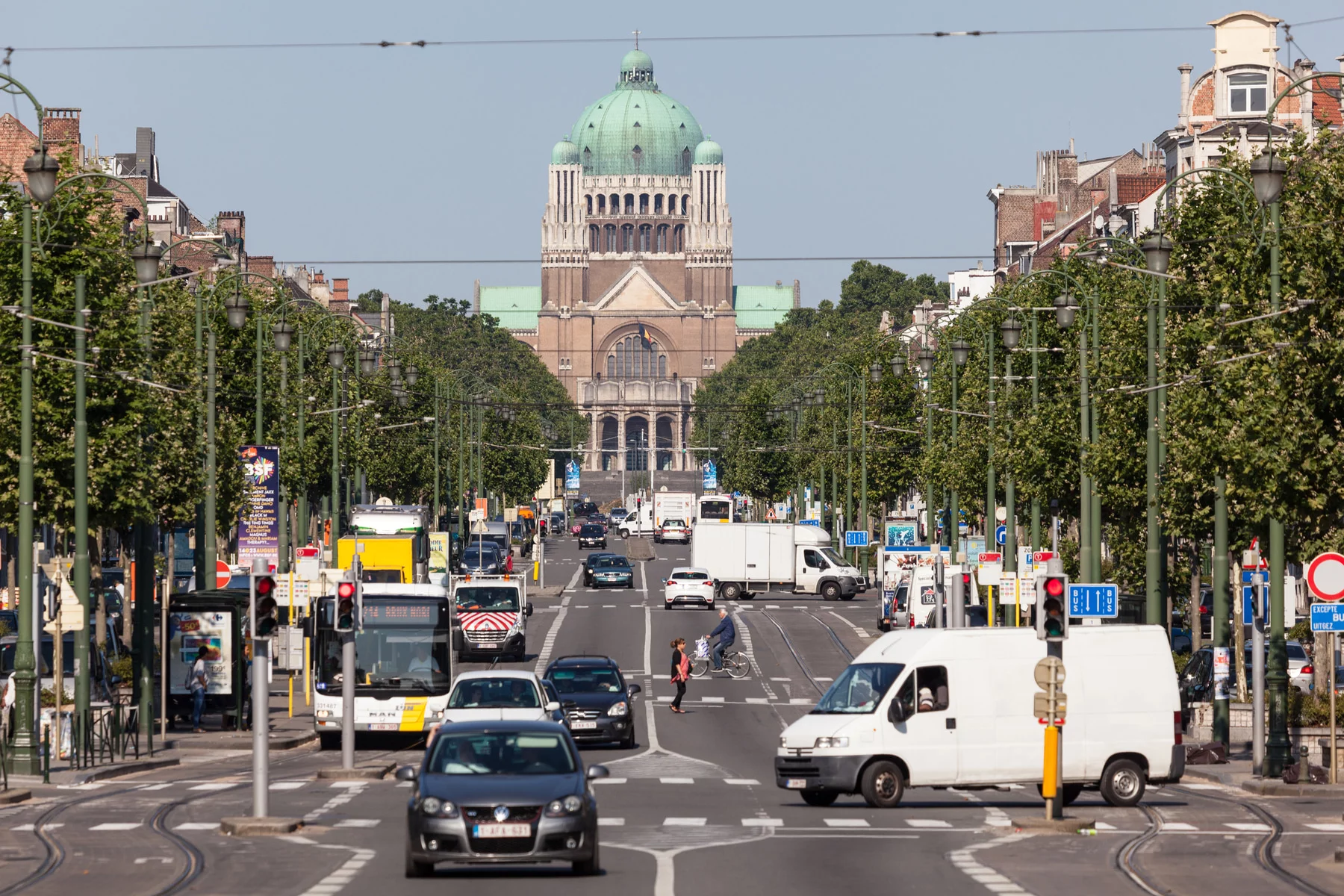 cars driving on the road in front of the basilica of the sacred heart in brussels