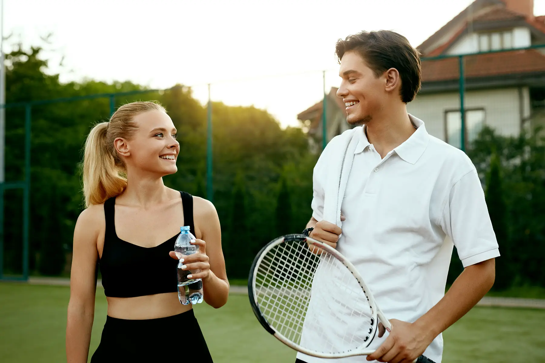 A couple taking a break from a game of tennis