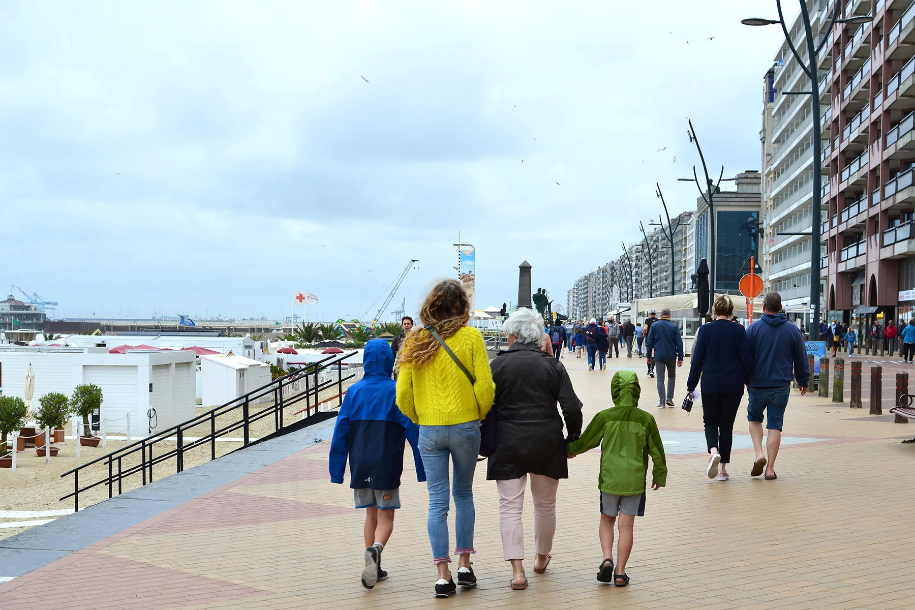 Family walking together along a boardwalk in Blankenberge, Belgium