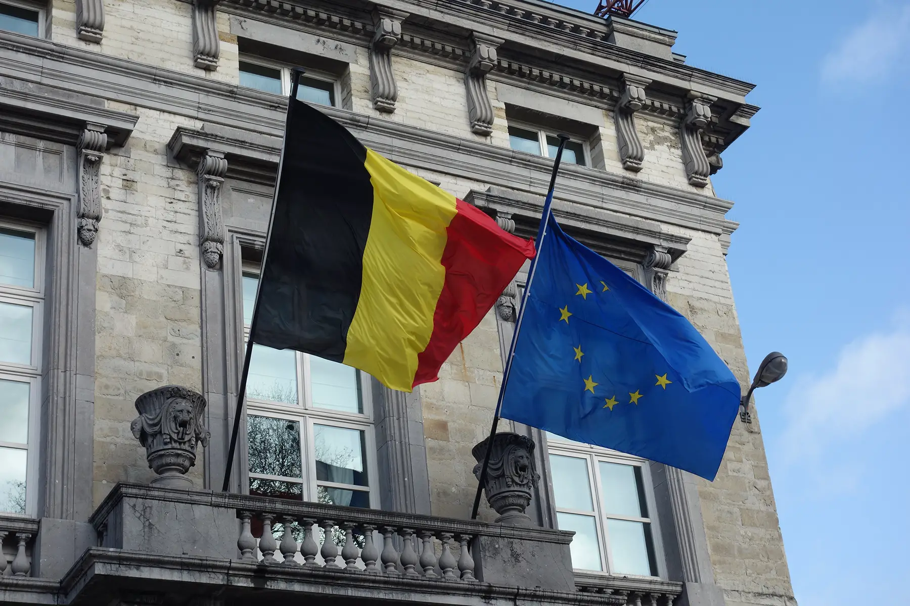 Flags hanging outside of the Belgian Parliament