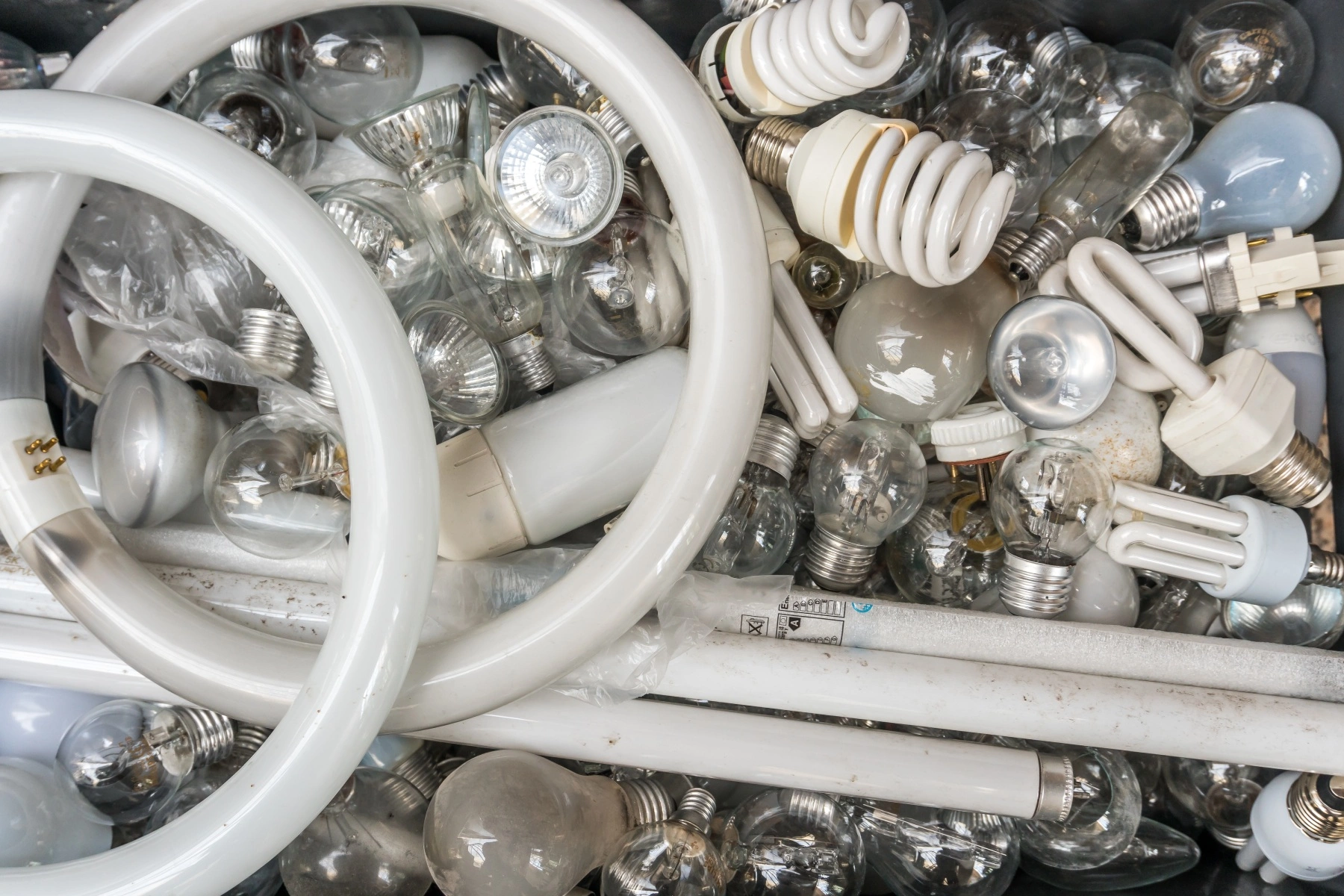 an aerial view of a container filled with used light bulbs ready to be recycled