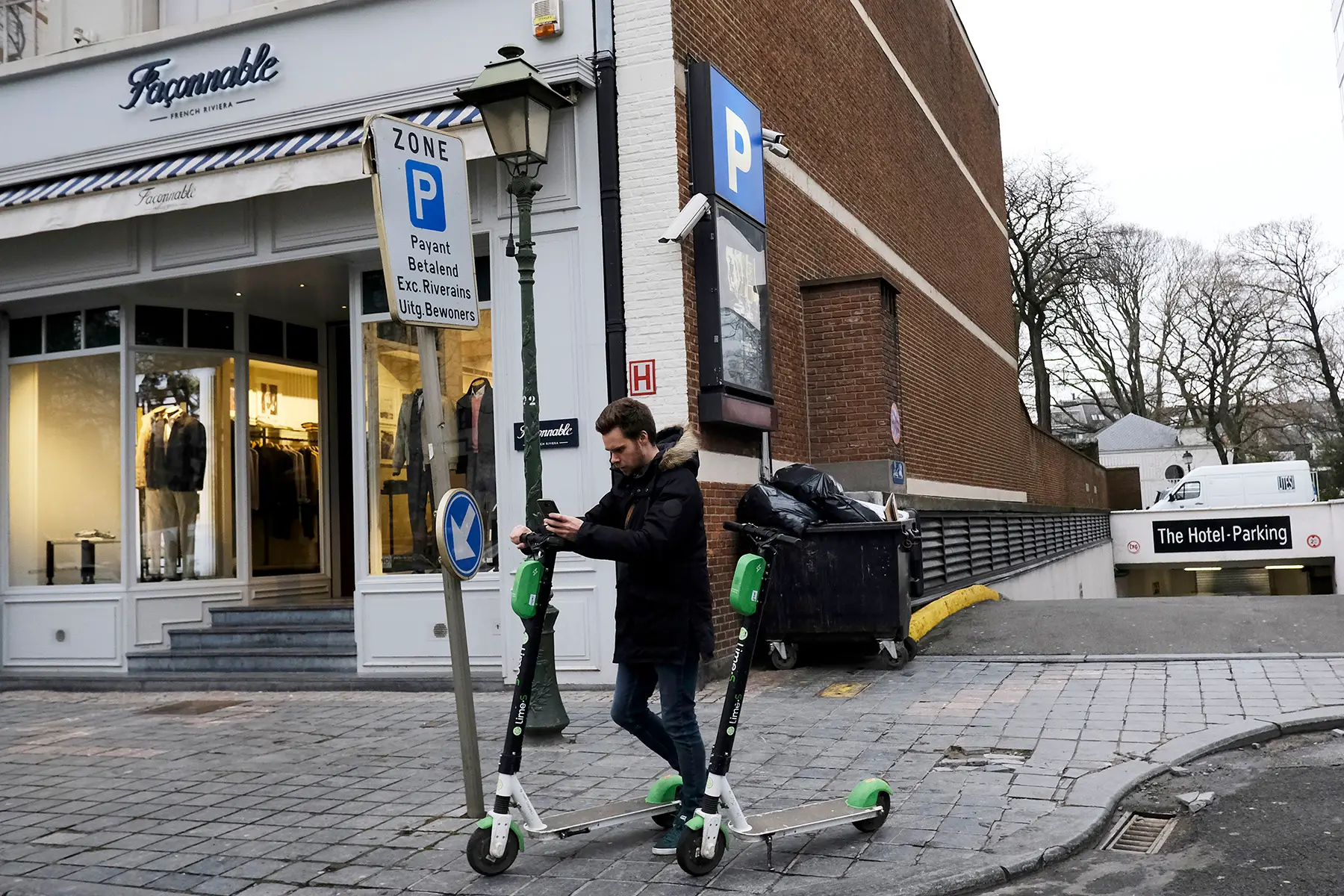 Man using a scooter-sharing app in Brussels, Belgium