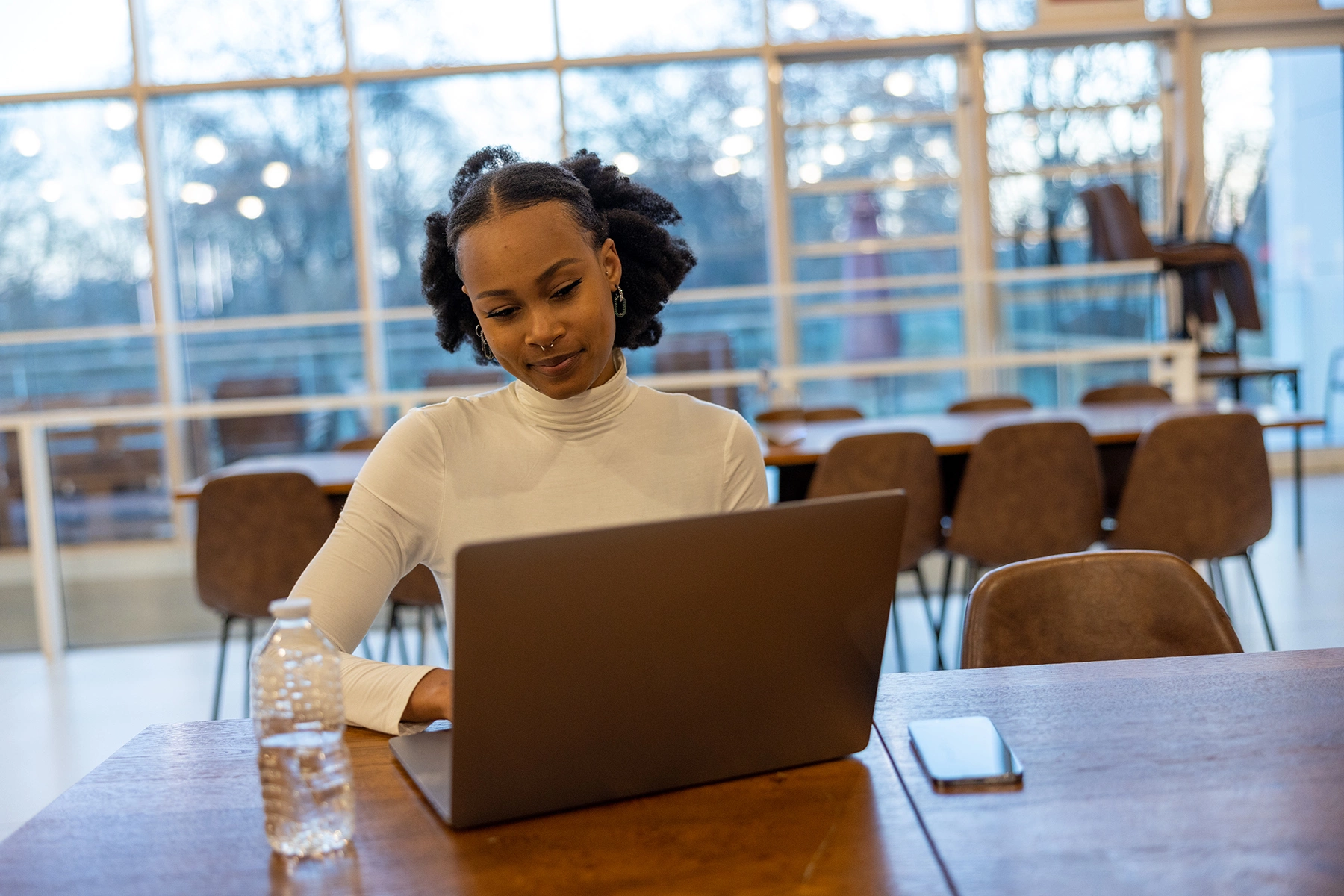 Young woman using a laptop in a library