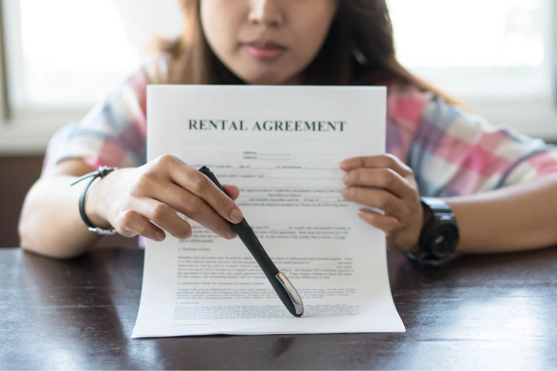woman showing where to sign a rental agreement