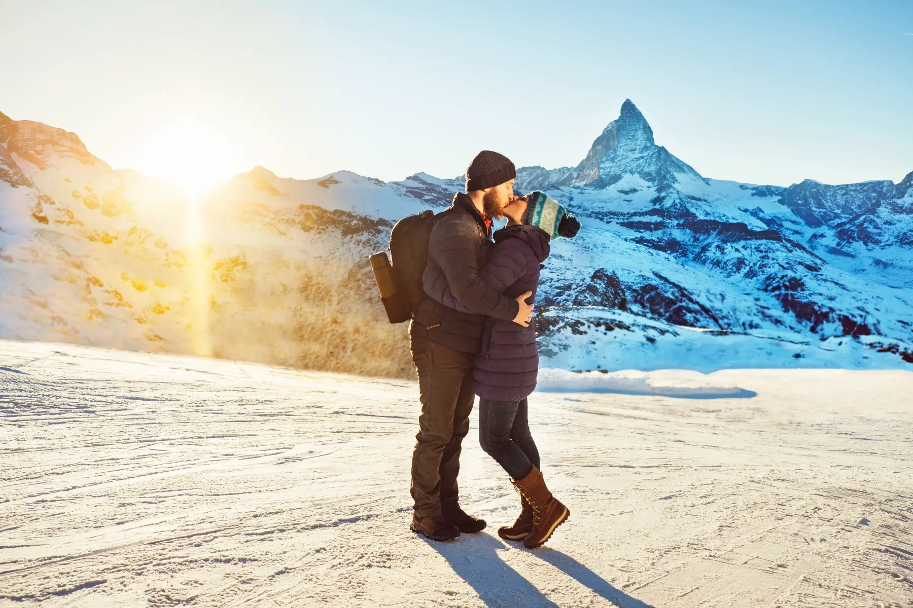 Couple kissing in the snowy Swiss Alps