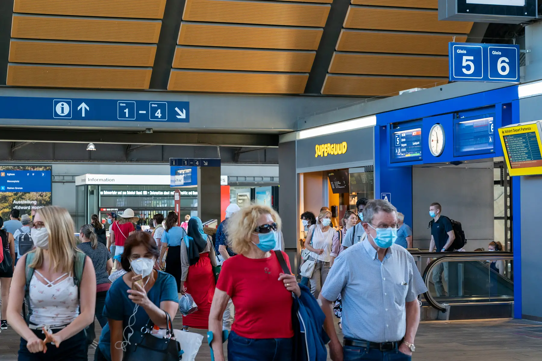 People wearing masks in Basel station