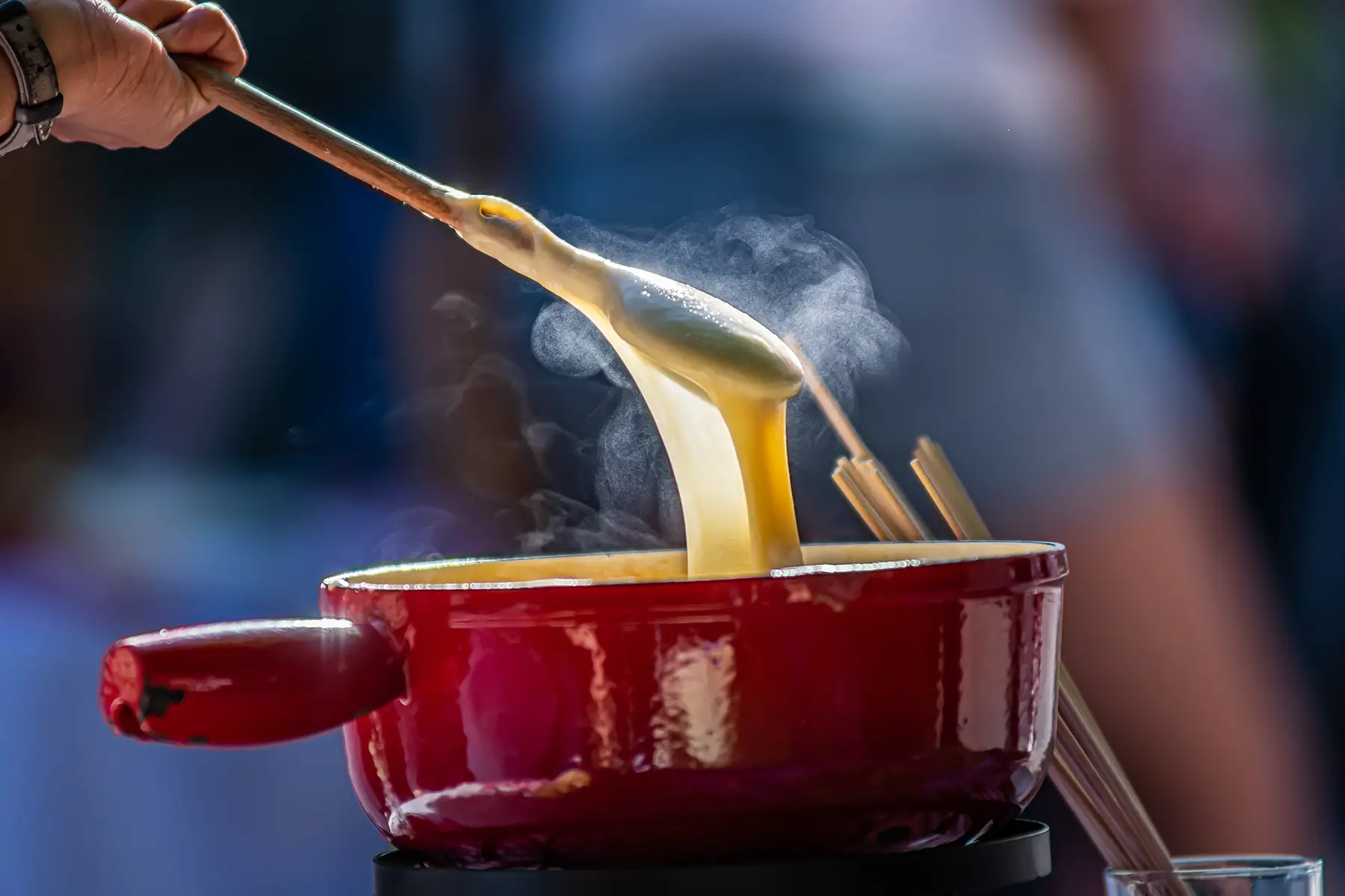 Chef stirring cheese fondue