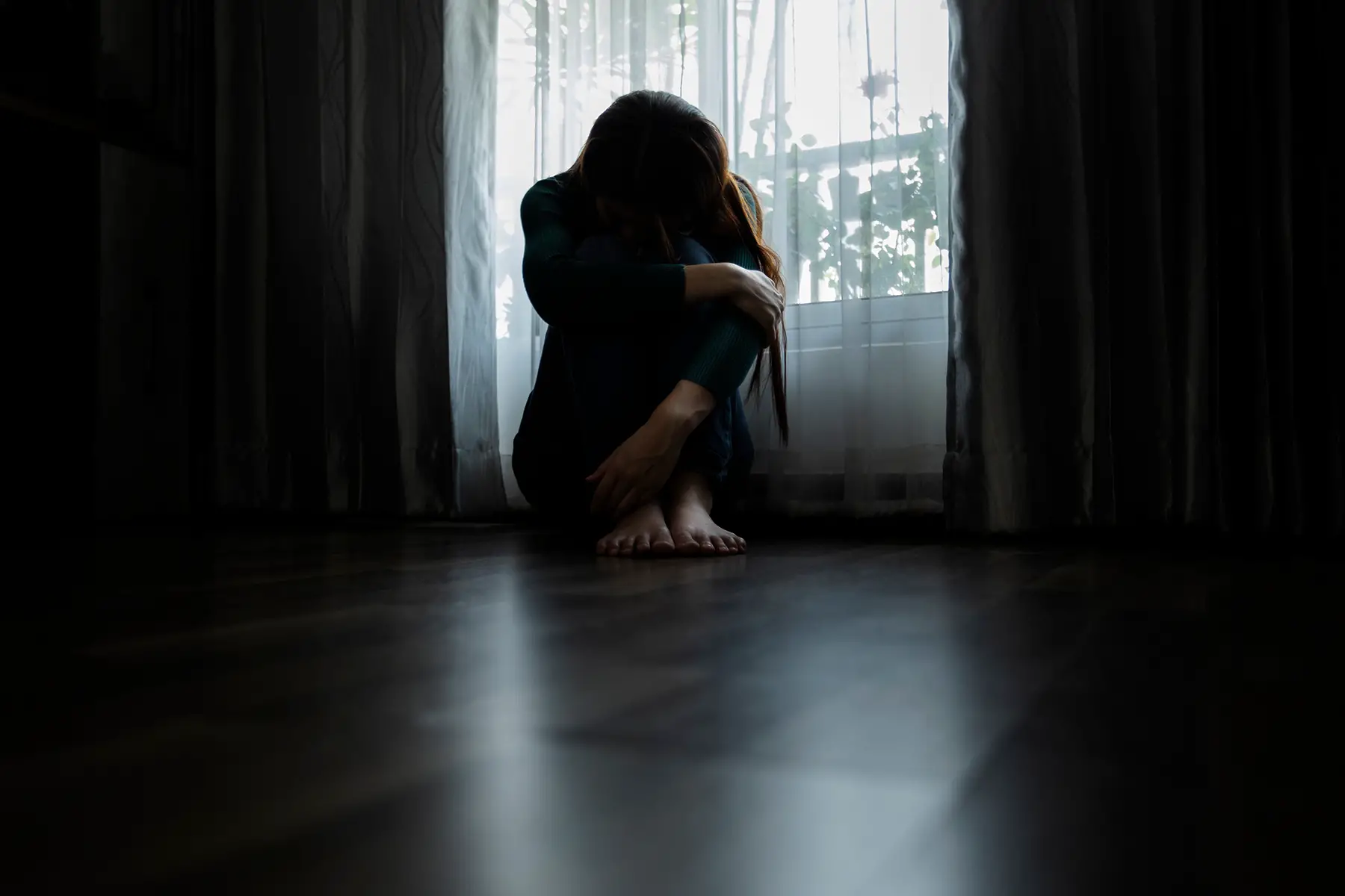 Domestic violence victim in a dark room