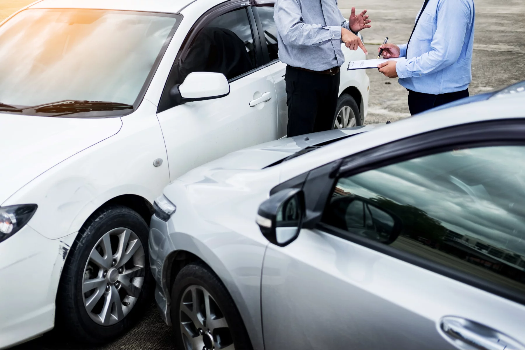 Drivers exchanging insurance details after a car crash