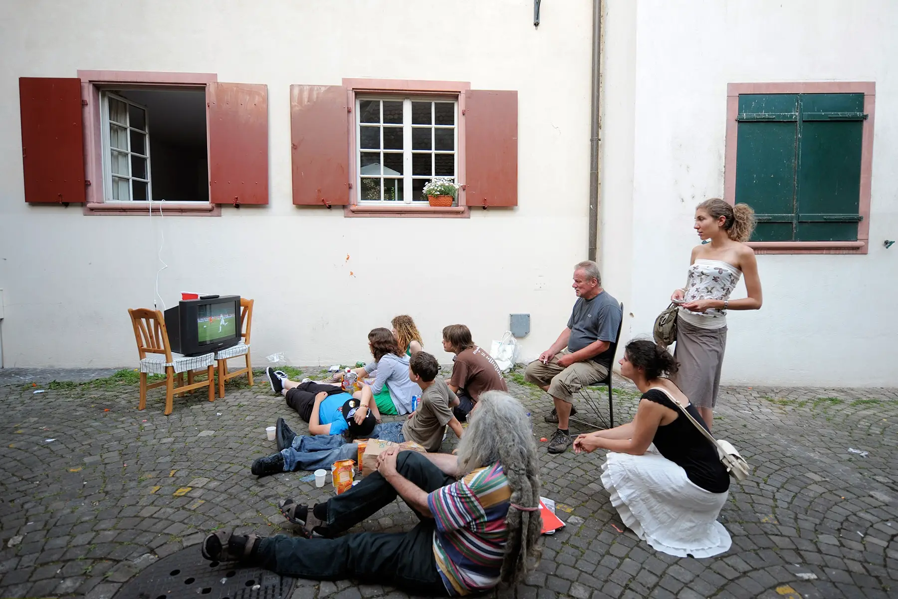 Family watching football on TV in Basel, Switzerland