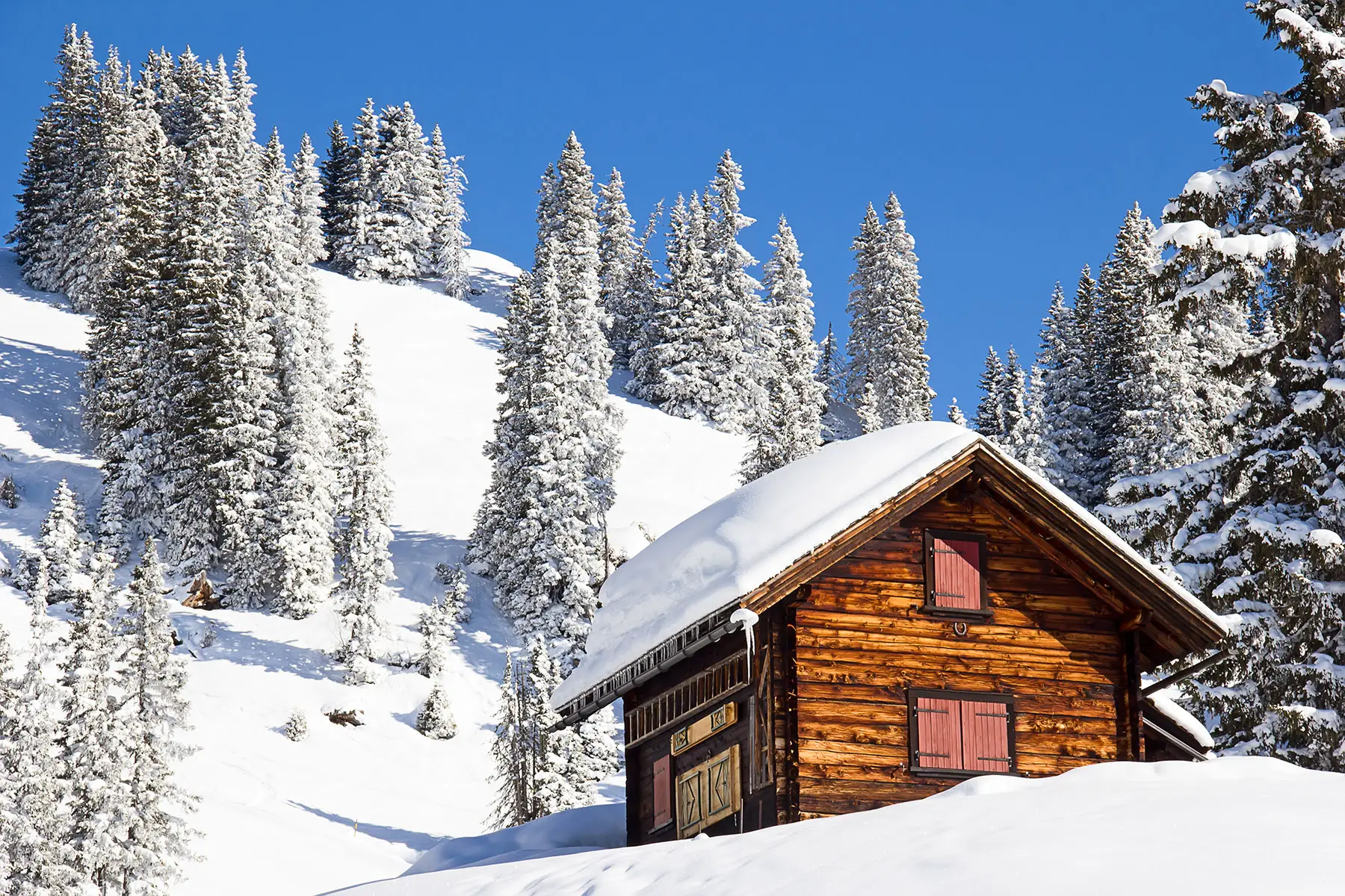 log cabin in snowy mountains in Switzerland