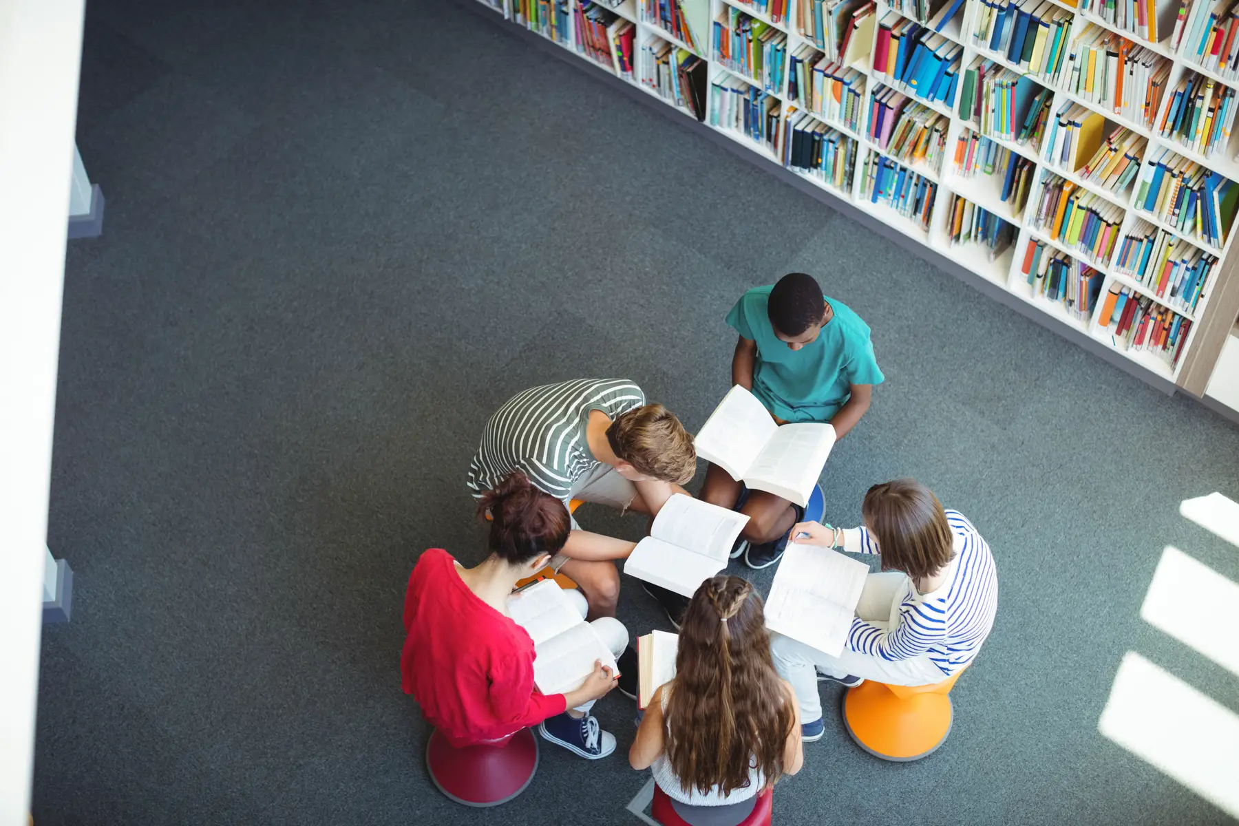 secondary school students studying for their exams in a library
