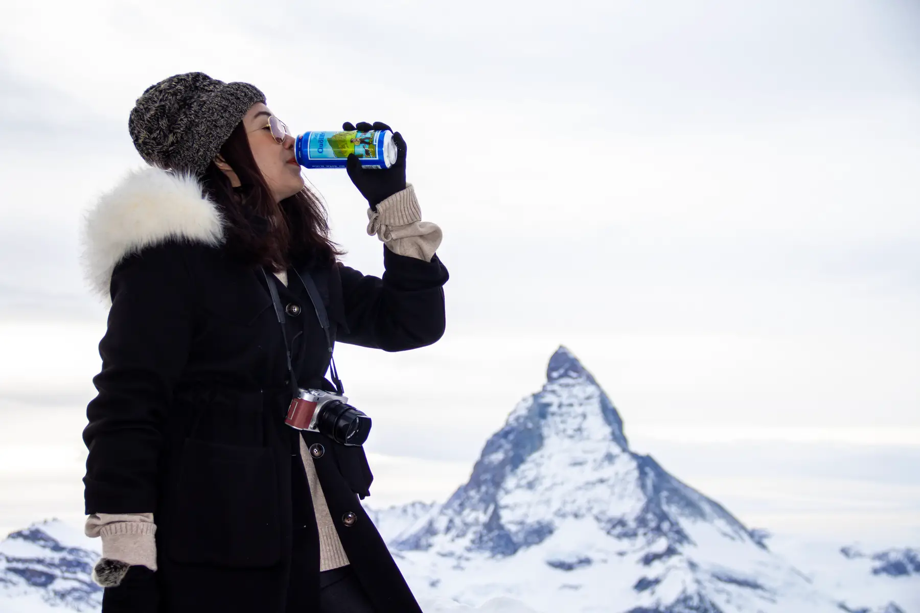 Woman drinking a can of Swiss beer