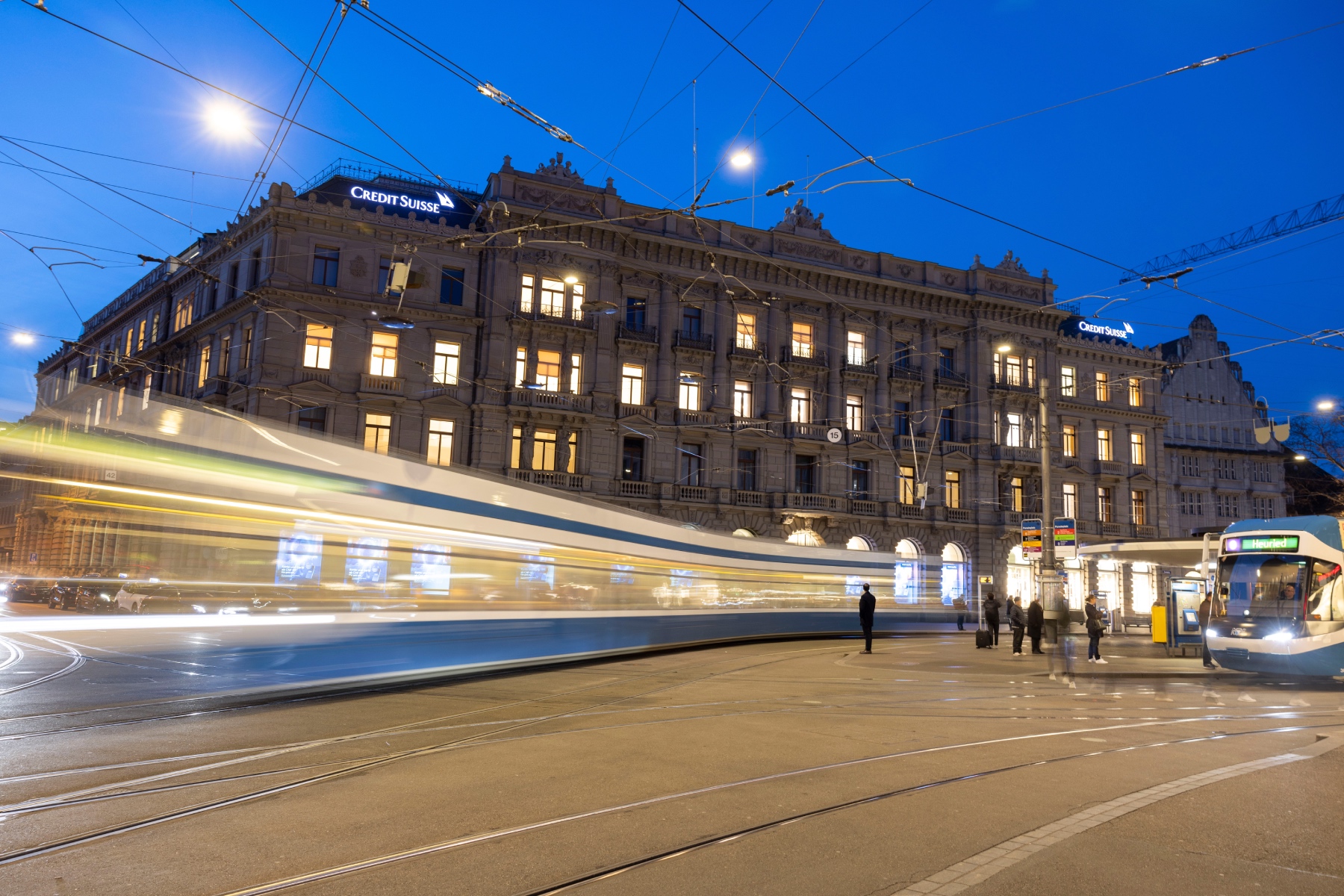 A zooming tram passes by Credit Suisse headquarters in Zürich