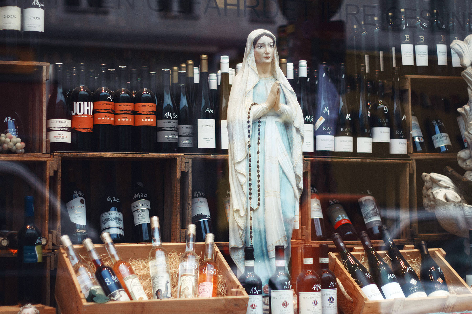 Closeup of a Mother Mary statue inside a wine store in Berlin, Germany.