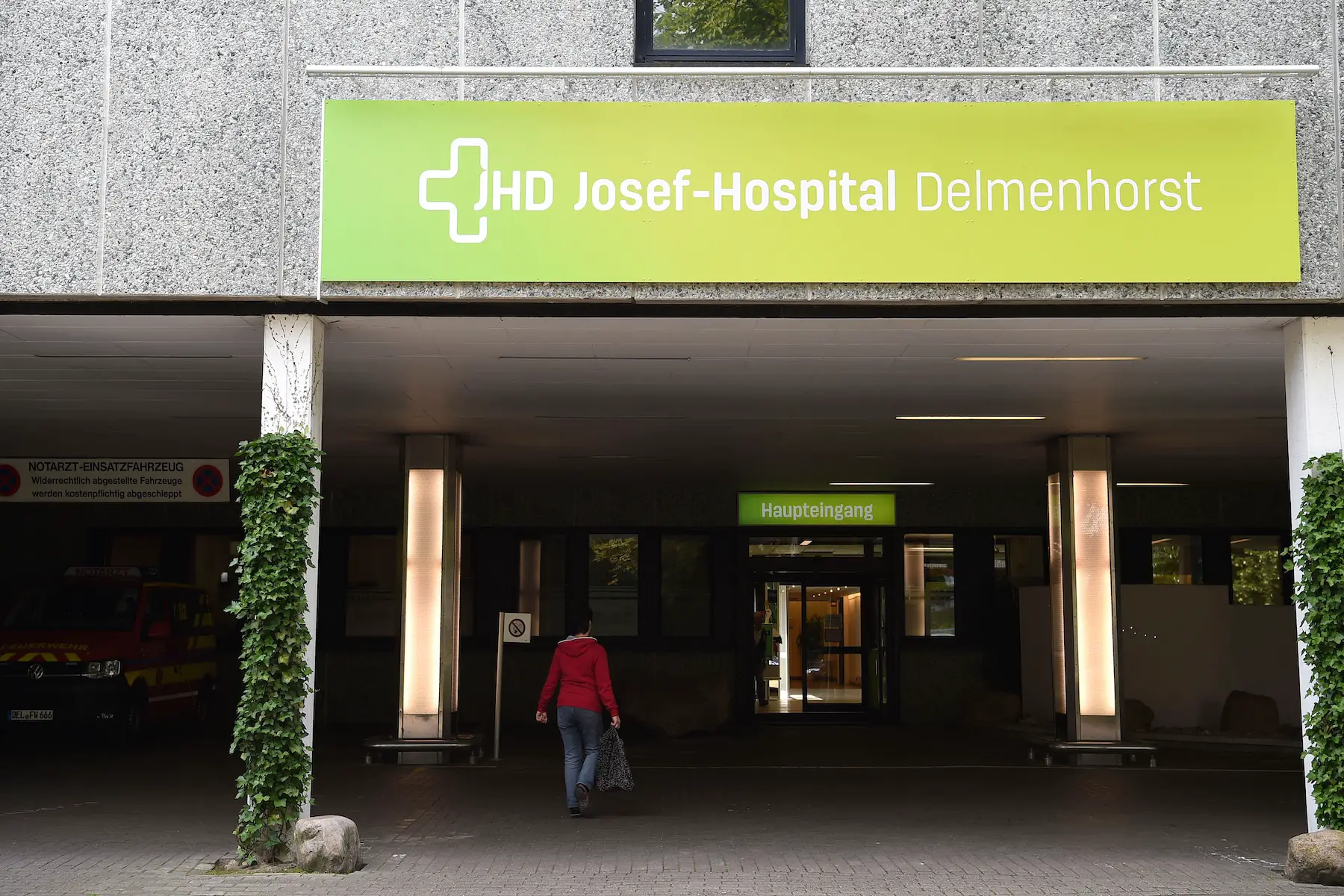 A person walks toward the entrance of Josef-Hospital in Delmenhorst, Germany.