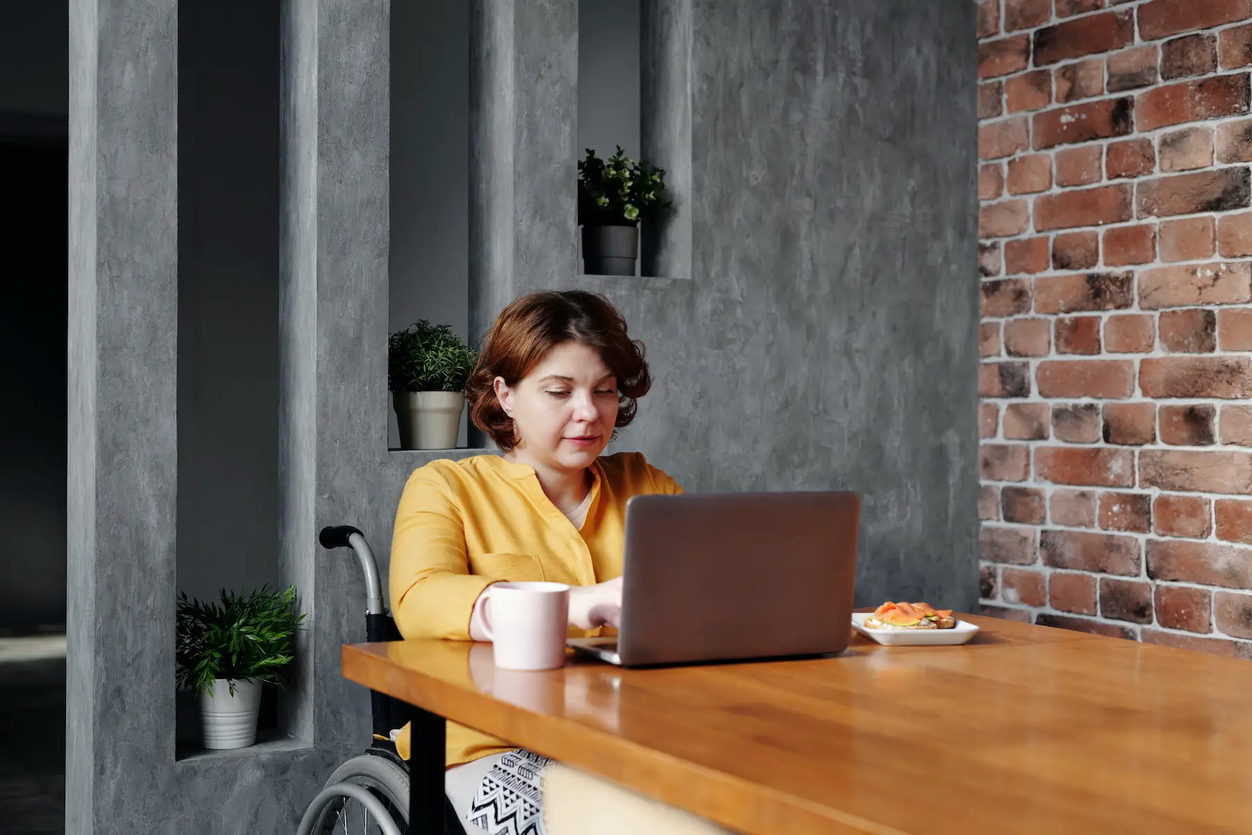Woman typing on laptop in office space