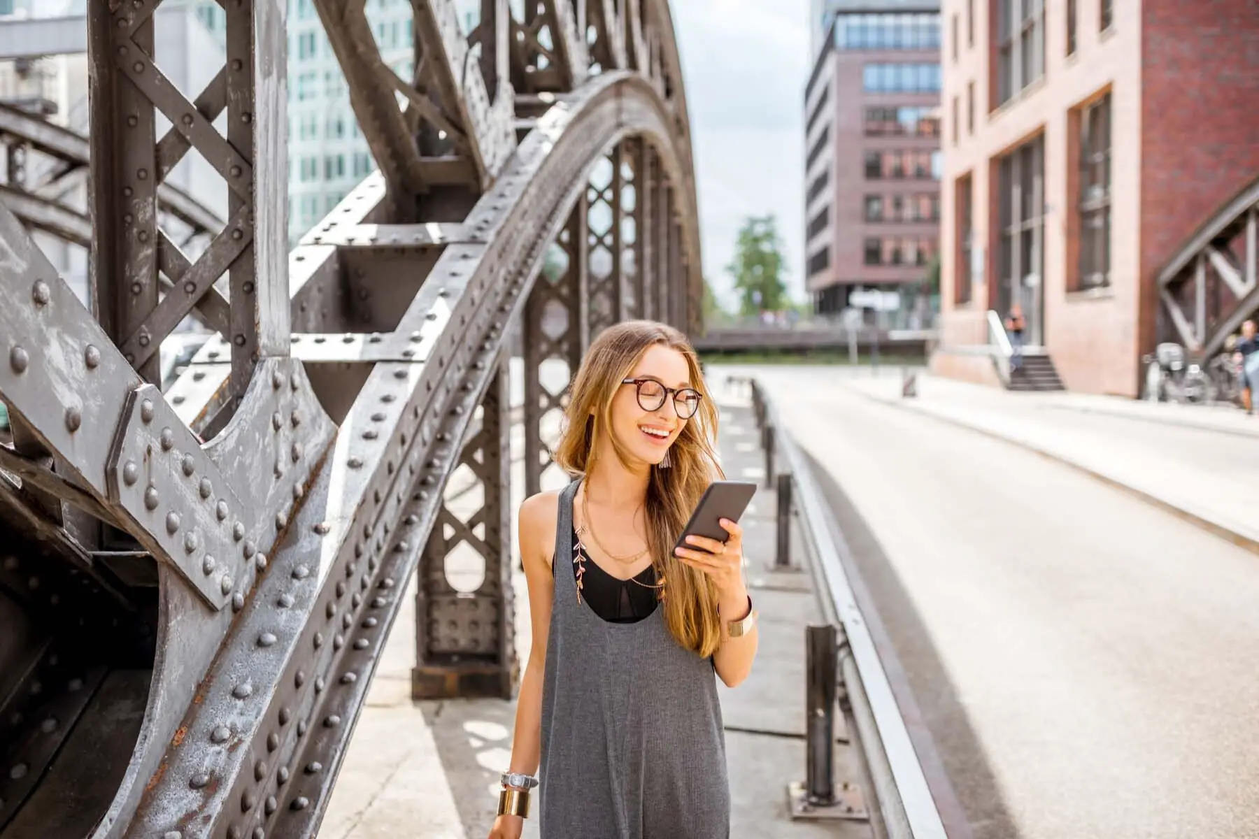 Smiling woman browsing German apps in street