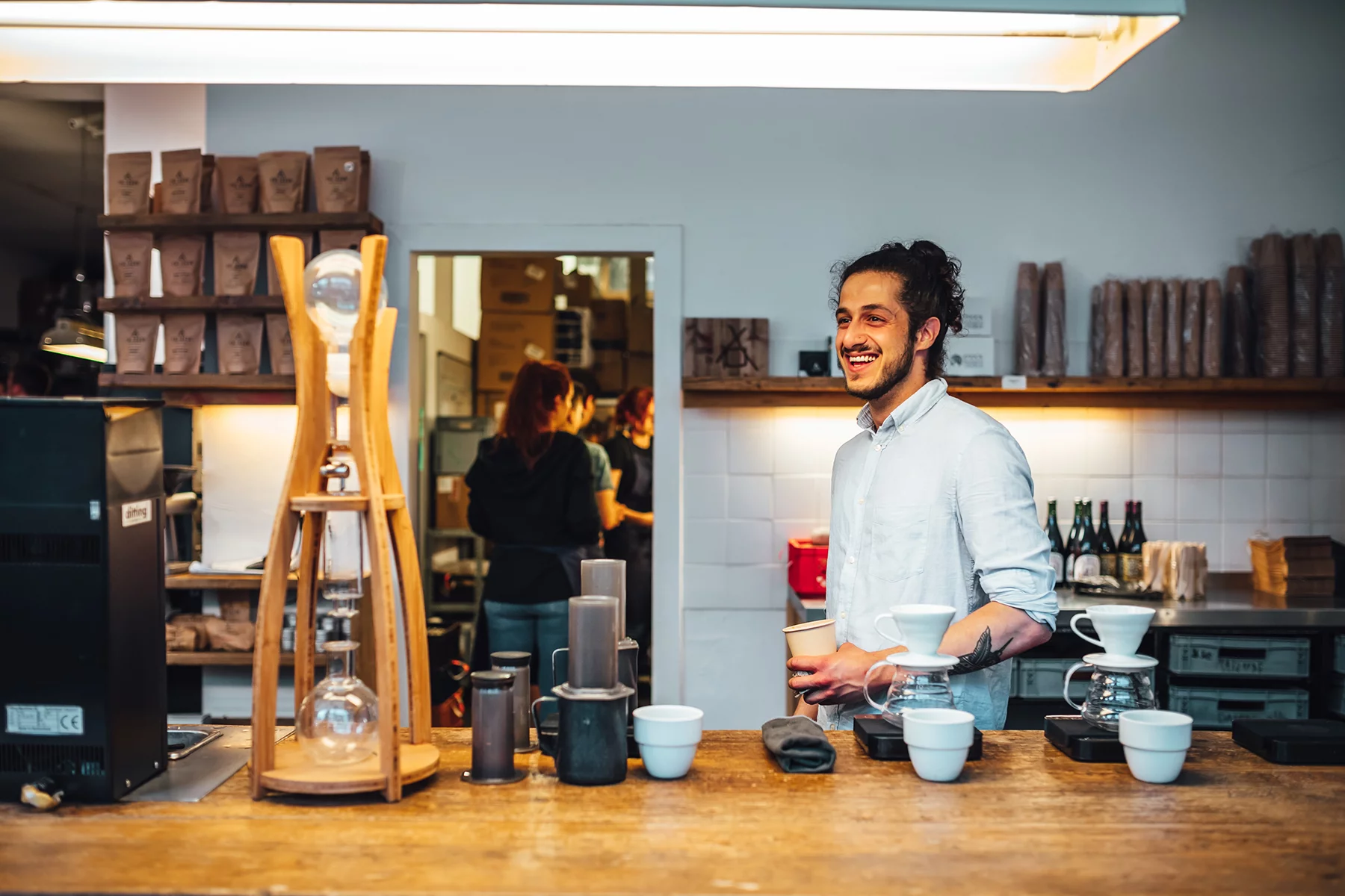 Smiling barista in a Berlin coffee bar