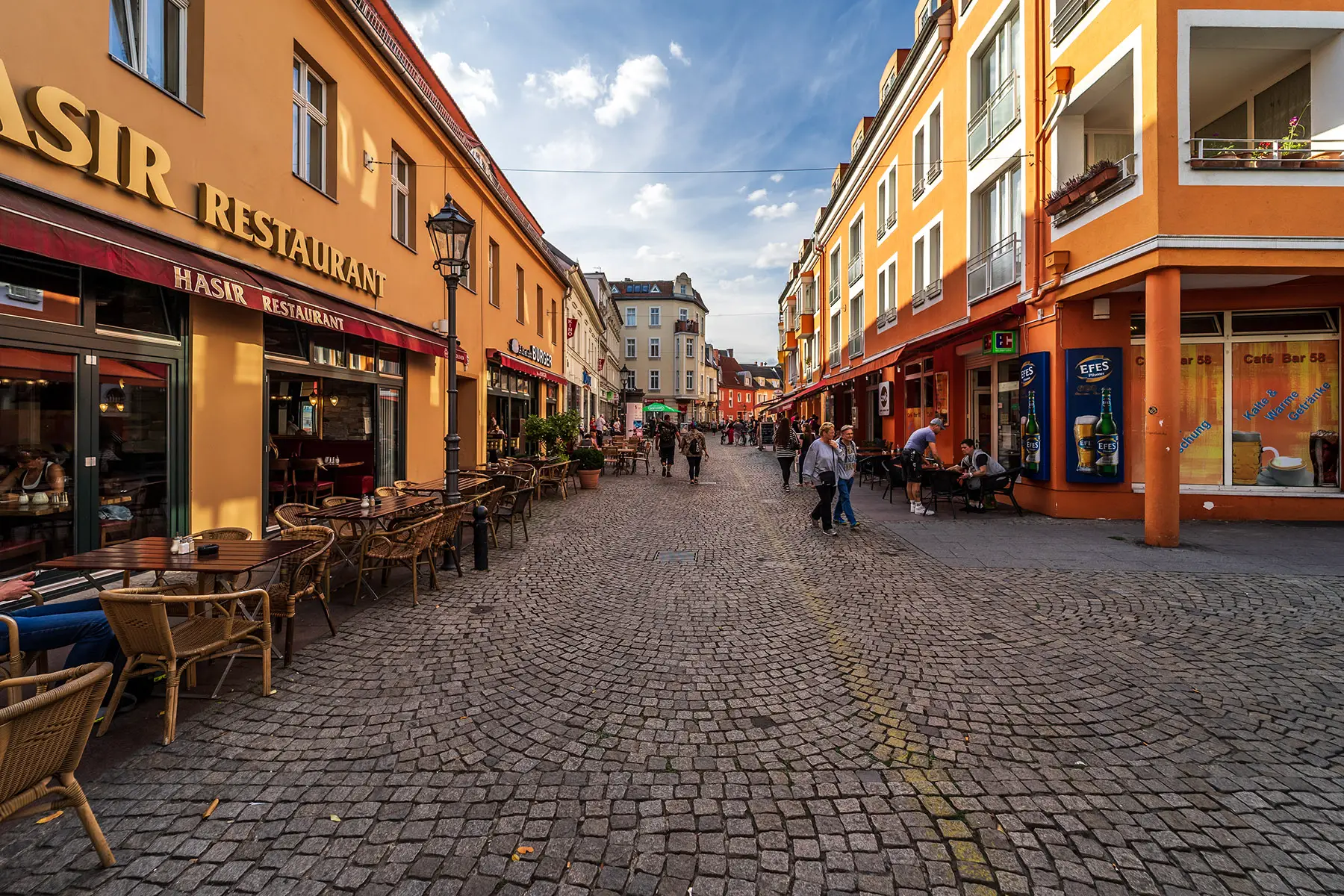 A street with outdoor terrace tables in Spandau, Berlin