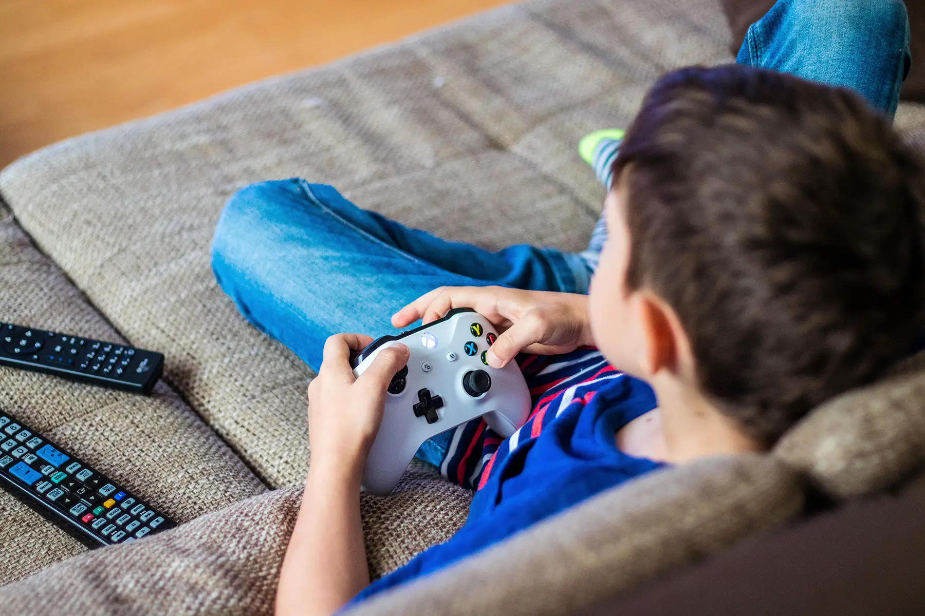 Boy sitting on the couch playing videogames